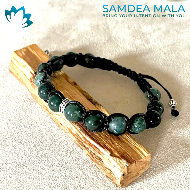 Samdea Mala – Tibetan-style Moss Agate bracelet for prosperity and renewal. Green moss agate gemstone bracelet with black cord and silver spacers.