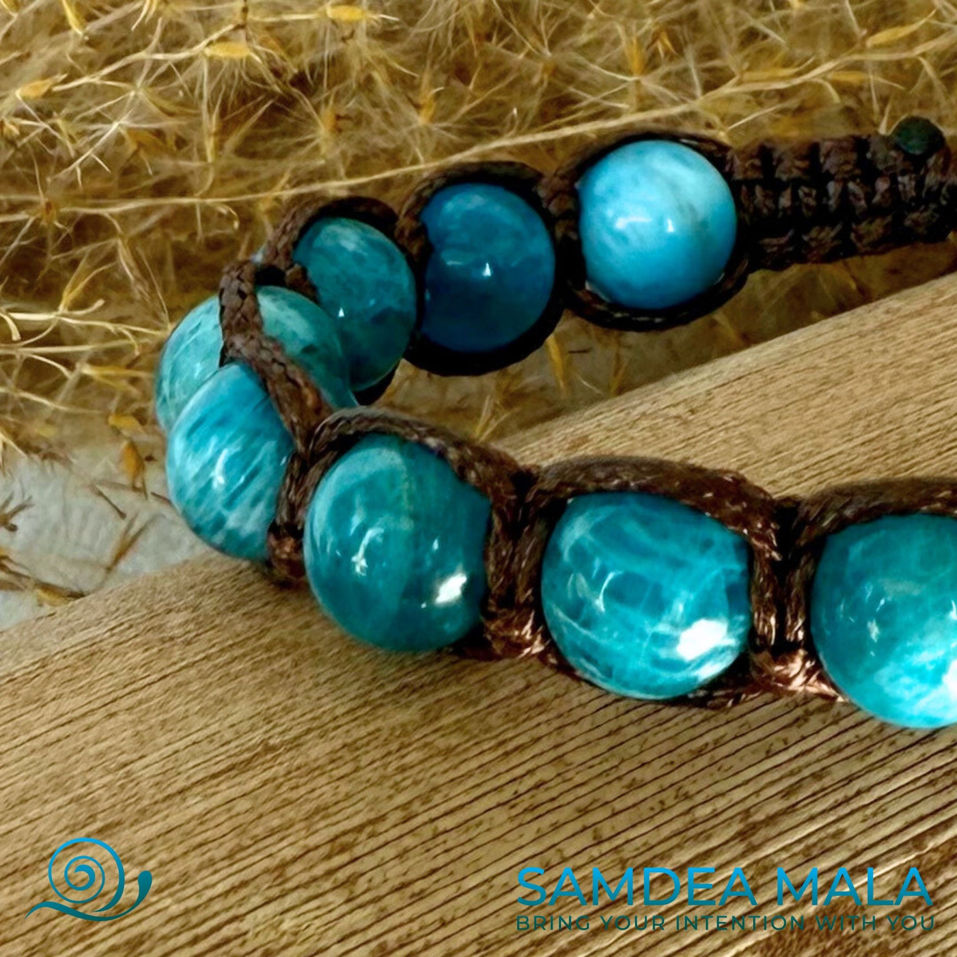 Close-up of Samdea Mala apatite Tibetan bracelet for emotional balance, good luck and support in hanges. Shamballa blue bracelet