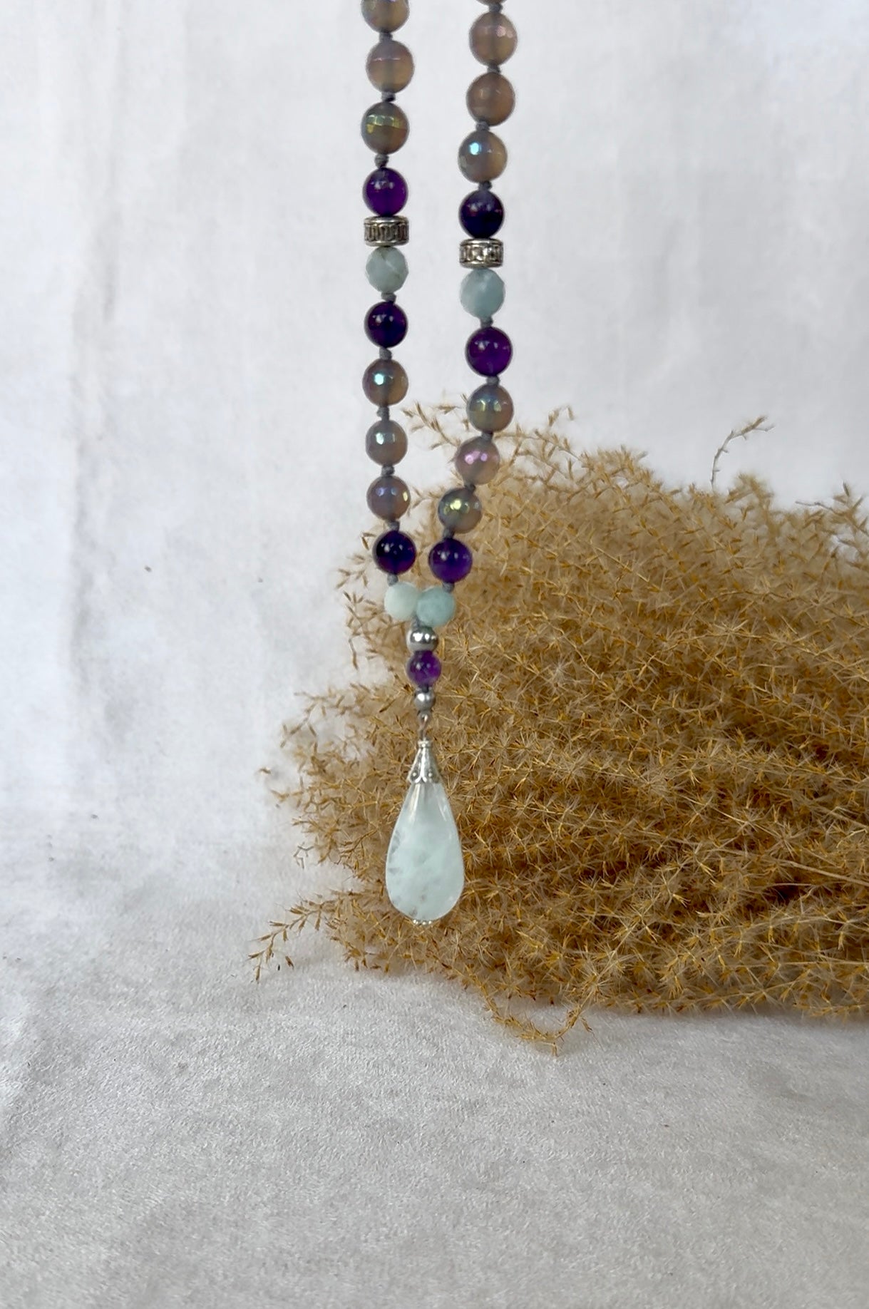 Aquamarine pendant on a spiritual mala necklace for meditation and inner peace, custom mala beads for meditation and mindfulness, tibetan prayer beads in agate, amethyst and aquamarine with small OM charm.