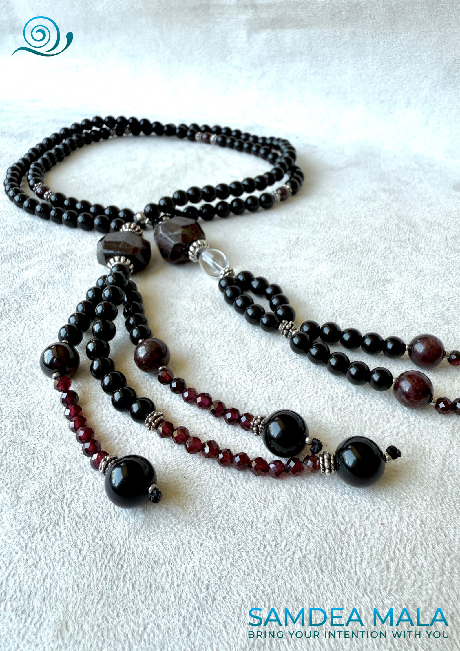 Handmade Nichiren Juzu with 108 natural obsidian and garnet beads, featuring clear quartz for spiritual clarity and protection – perfect for chanting Nam Myoho Renge Kyo.