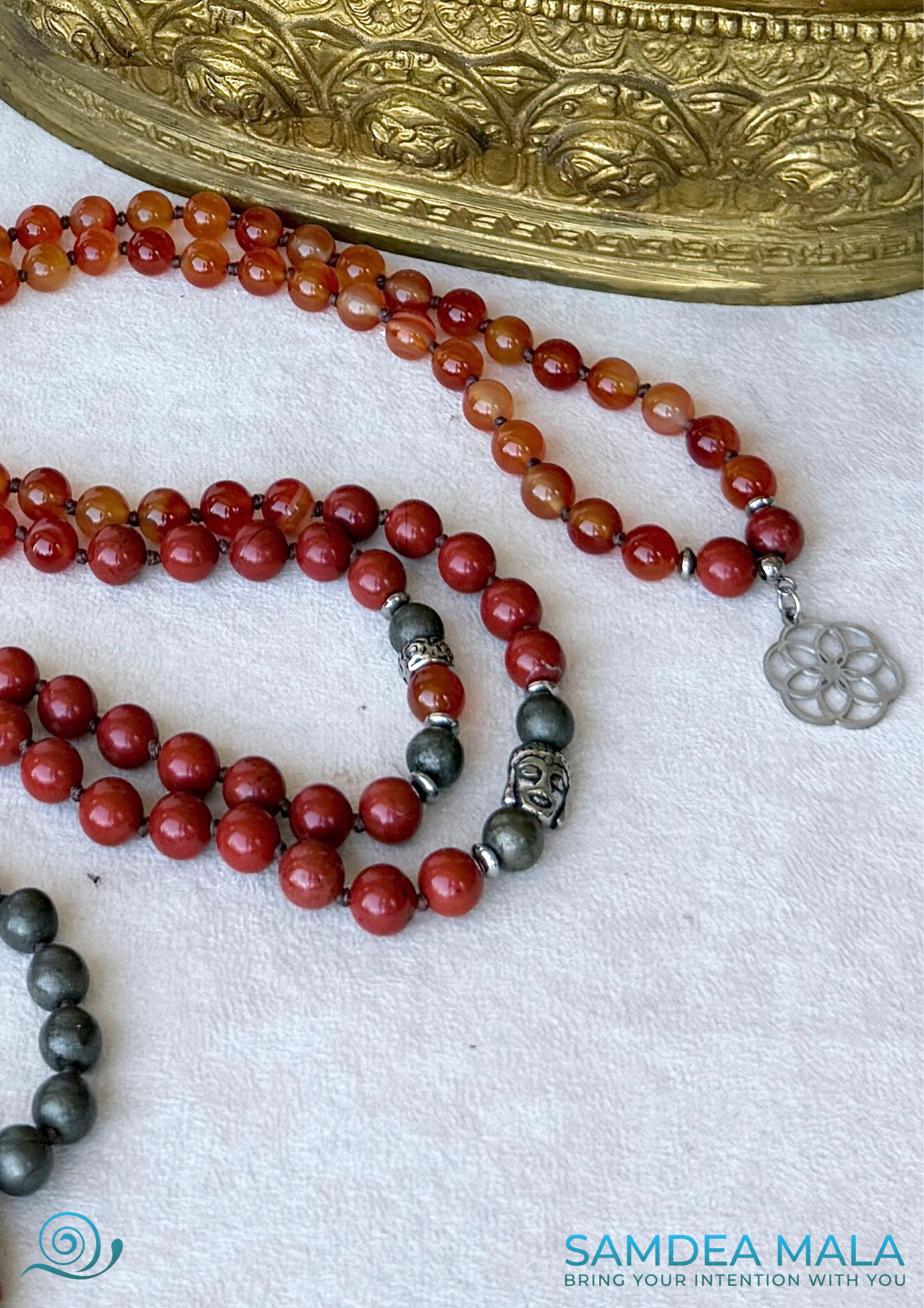 close up pf Buddha charm and seed of life small penadant - detail for mindfulness and inner peace, Samdea grounding mala with natural stones. Zodiac sign Aries Mala for meditation