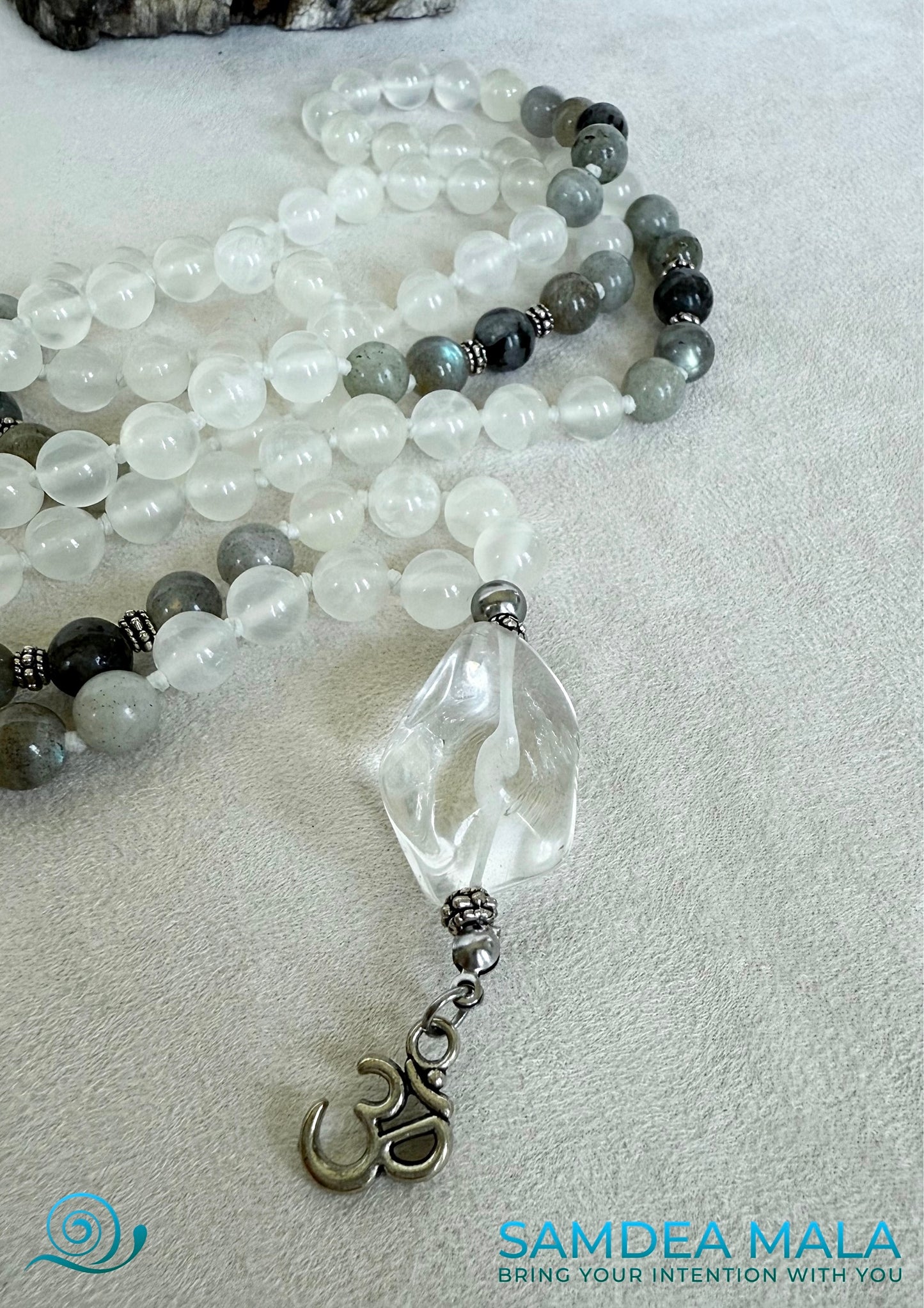 Close-up of White Mala for meditation in selenite, Mala necklace with om pendant, Custom mala beads for purification and success with om pendant. Natural gemstone mala
