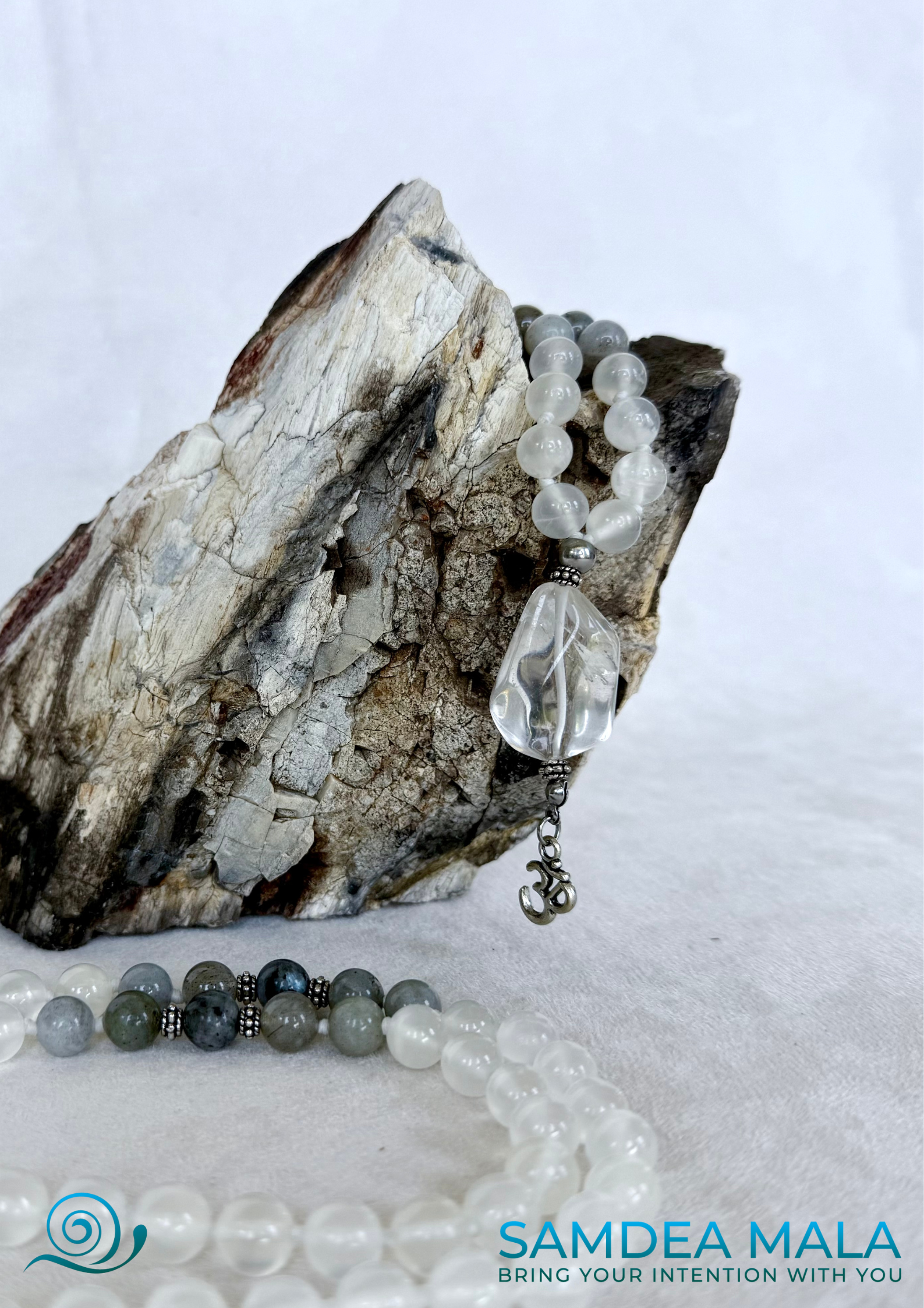 Close-up of White Mala for meditation in selenite, labradiorite and clear quartz qwith small om pendant