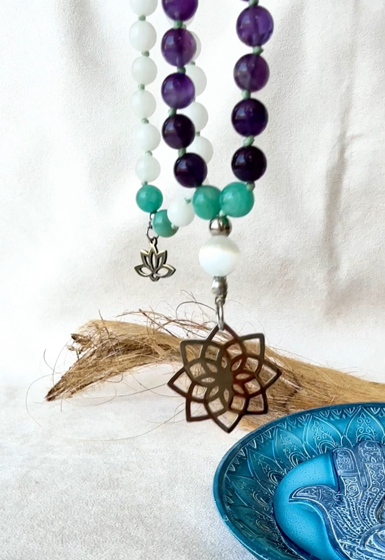 Close-up of hand-knotted mala with seed of life pendant, lotus charm and calming gemstone beads – spiritual necklace for meditation and clarity. Mala for Pisces Zodiac Sign