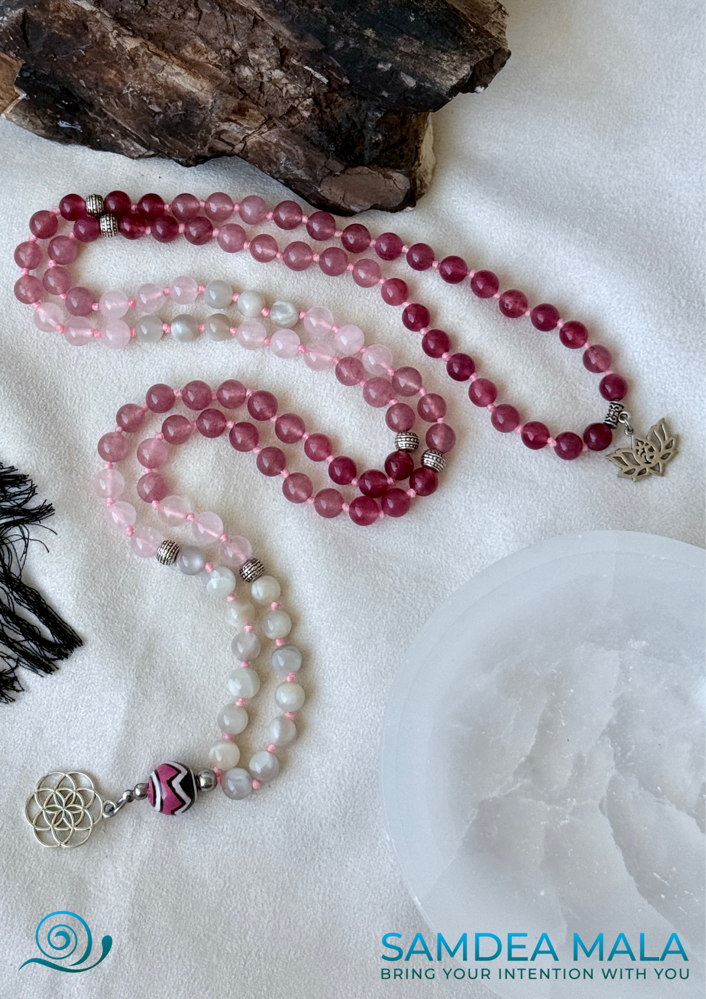 Samdea Mala made of moonstone, rose quartz, and strawberry quartz with ceramic meru bead, Seed of Life pendant. Feminine energy mala beads on natural background