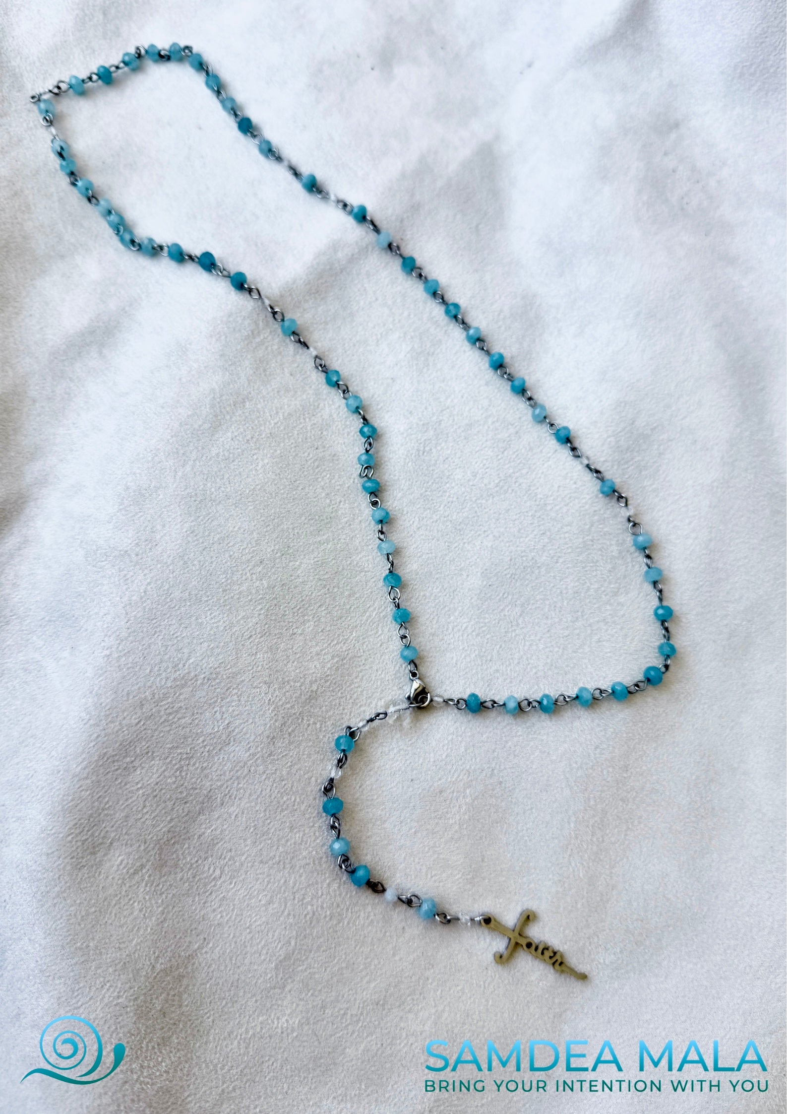 Full view of natural aquamarine rosary necklace, Classic Roman Catholic rosary, handmade with stainless steel cross "faith". Prayer necklace, wearable rosary, rosary jewelry, rosary gift, spiritual jewelry, handmade rosary, crystal rosary, clear quartz, catholic beads, devotion gift, gemstone rosary.