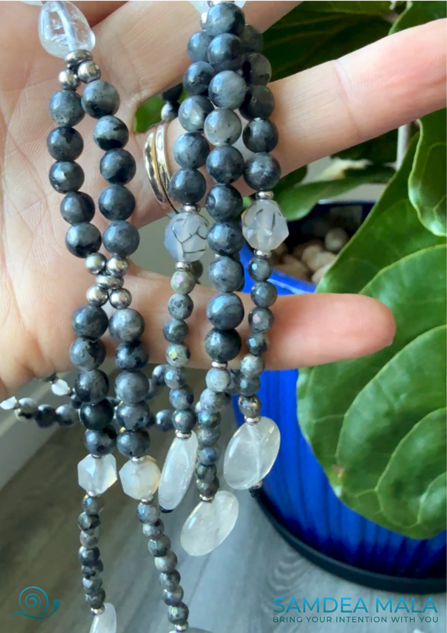 Gray SGI juzu with tassels on a hand