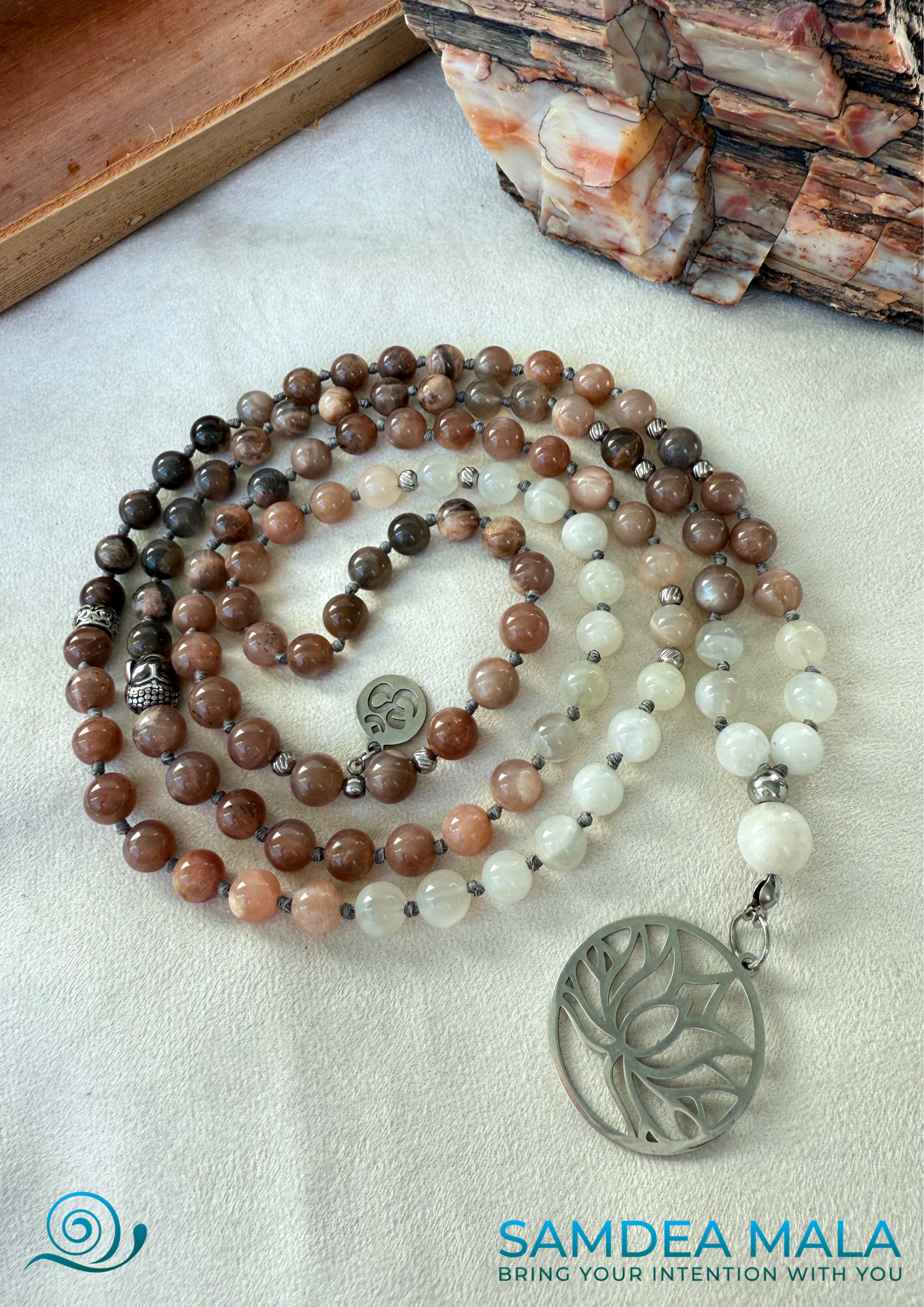 Samdea Mala - Full view of Moonstone Mala with Buddha, Lotus and OM – Hand-Knotted mala  Feminine Energy Mala | Intuition Mala with Lotus Pendant | 108 Beads | Self-Connection & Lunar Magic. Handcrafted in US. 108 moonstone beads in soft pink and gray hues, Spiritual jewelry for intuition, lunar energy, and inner self-connection.