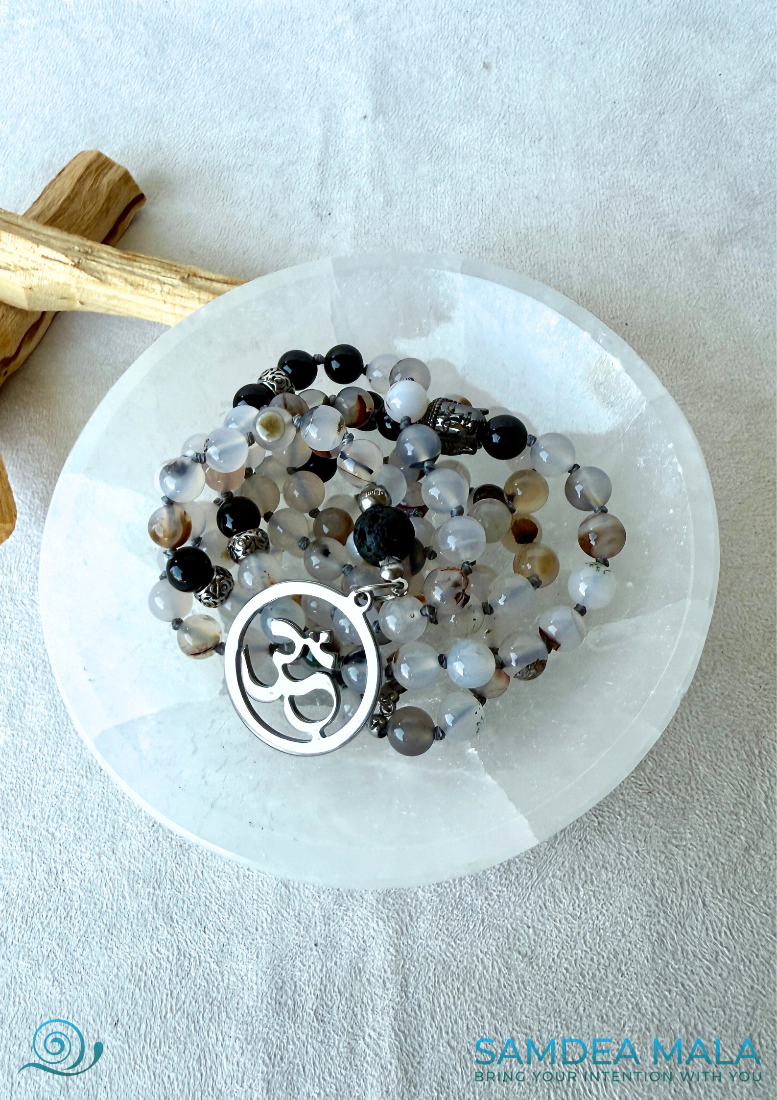 Handmade mala beads necklace in Dendritic Agate, Black Tourmaline, and Lava Stone for protection and balance on a selenite bowl. Gemini Zodiac Sign Mala by Samdea Mala