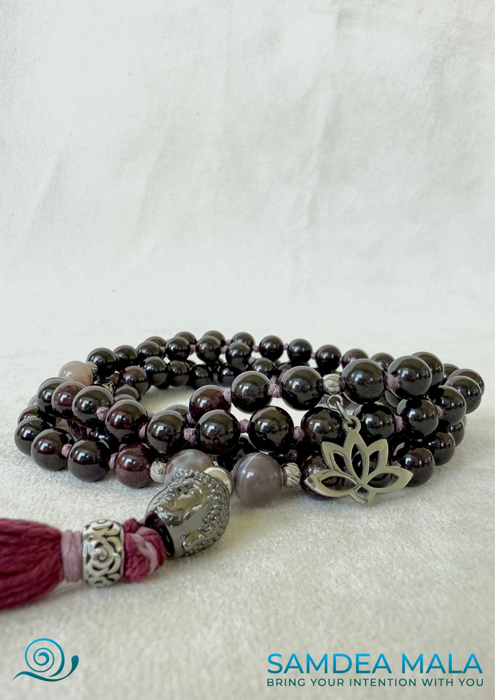 Close-up Samdea Mala Custom mala with tassel; purple, bordeaux mala beads with Buddha and lotus charm, for protection and light.