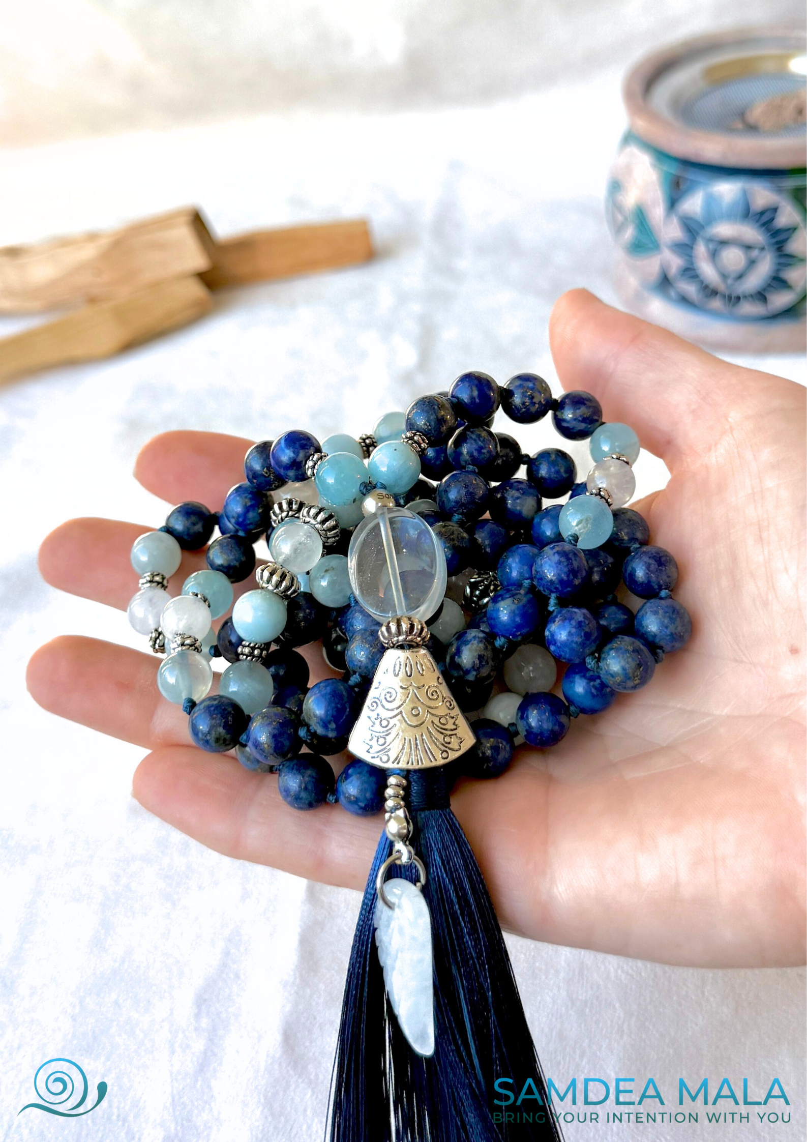 White jade Tibetan wing pendant on the Mala necklace for Libra zodiac sign, symbolizing peace, freedom, and spiritual growth hold on a hand