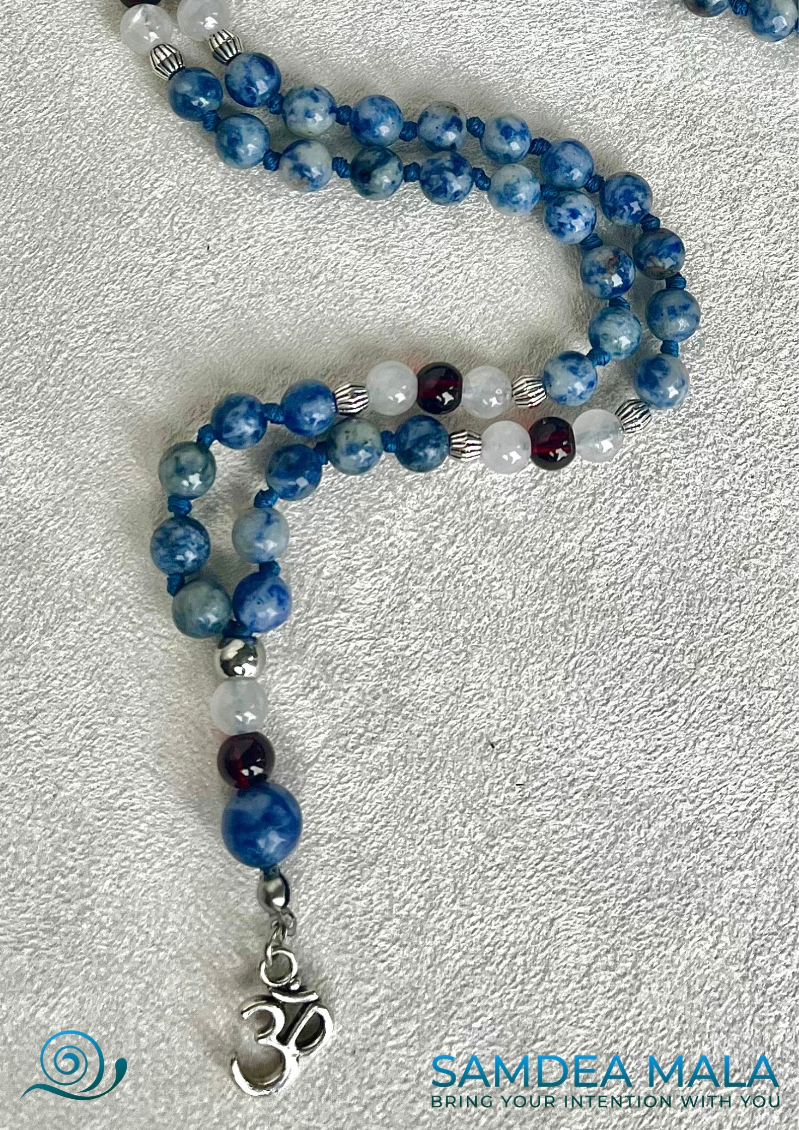Mini Mala in Blue Jasper, White Jade & Garnet: om pendant close-up– Handmade Meditation Necklace -  intention mala, spiritual mala, natural gemstones mala - Samdea Mala