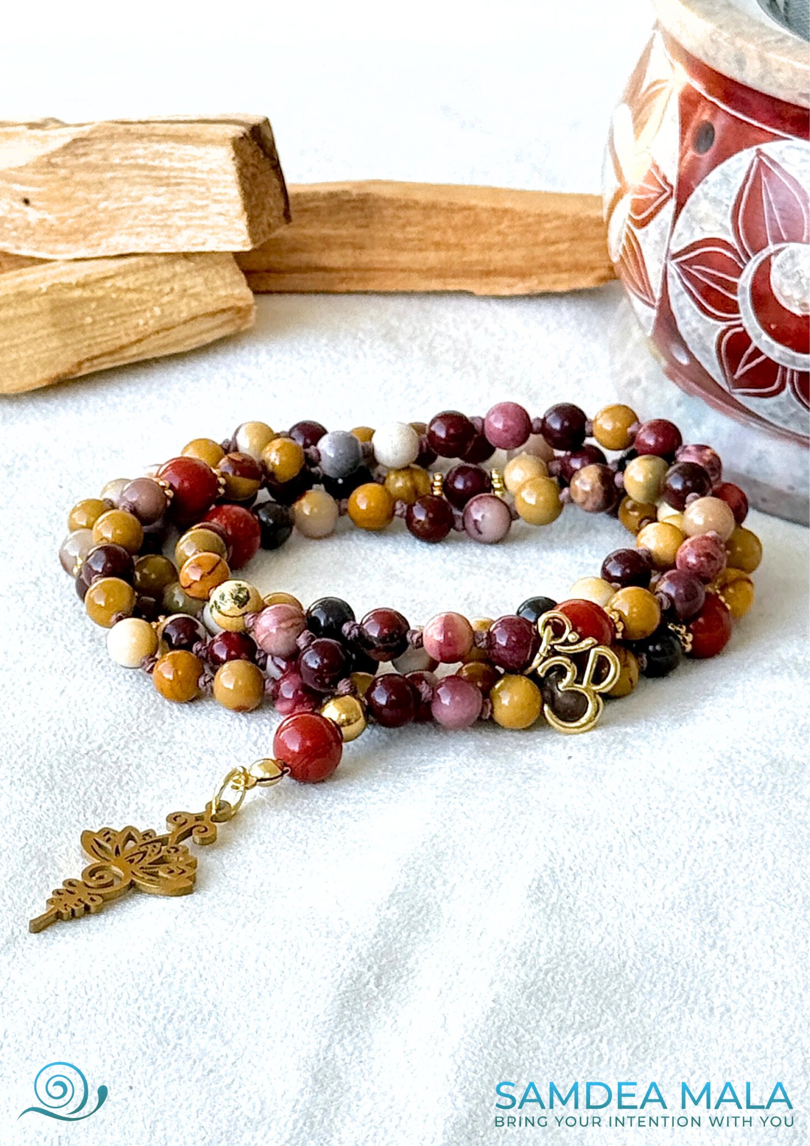 Mini mala for resilience and spiritual growth in mookaite and red jasper with unalome and lotus pendant an small om charm. Samdea Mala