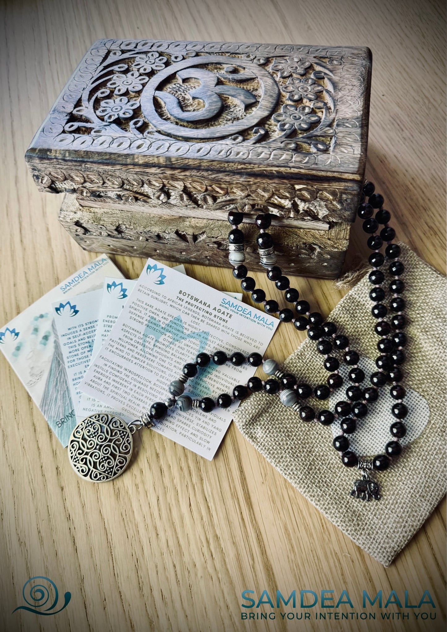 Packaging Samdea Mala Guru Mala beads with carved wood spiritual jewelry box