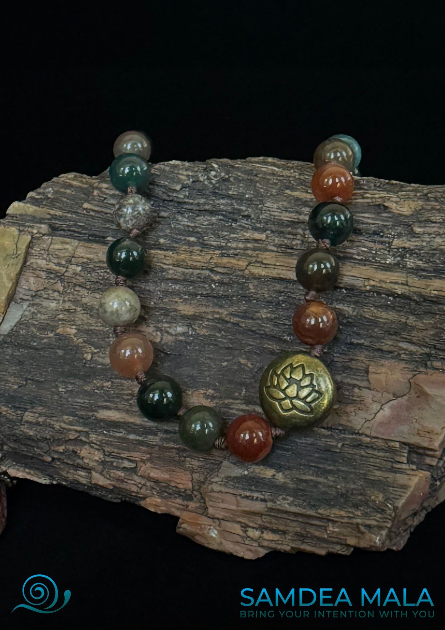 Close up of lotus bead of mala bracelet used in daily mindfulness rituals. Half mala with grounding stones for emotional balance. Sandalwood mala bracelet worn as everyday accessory.