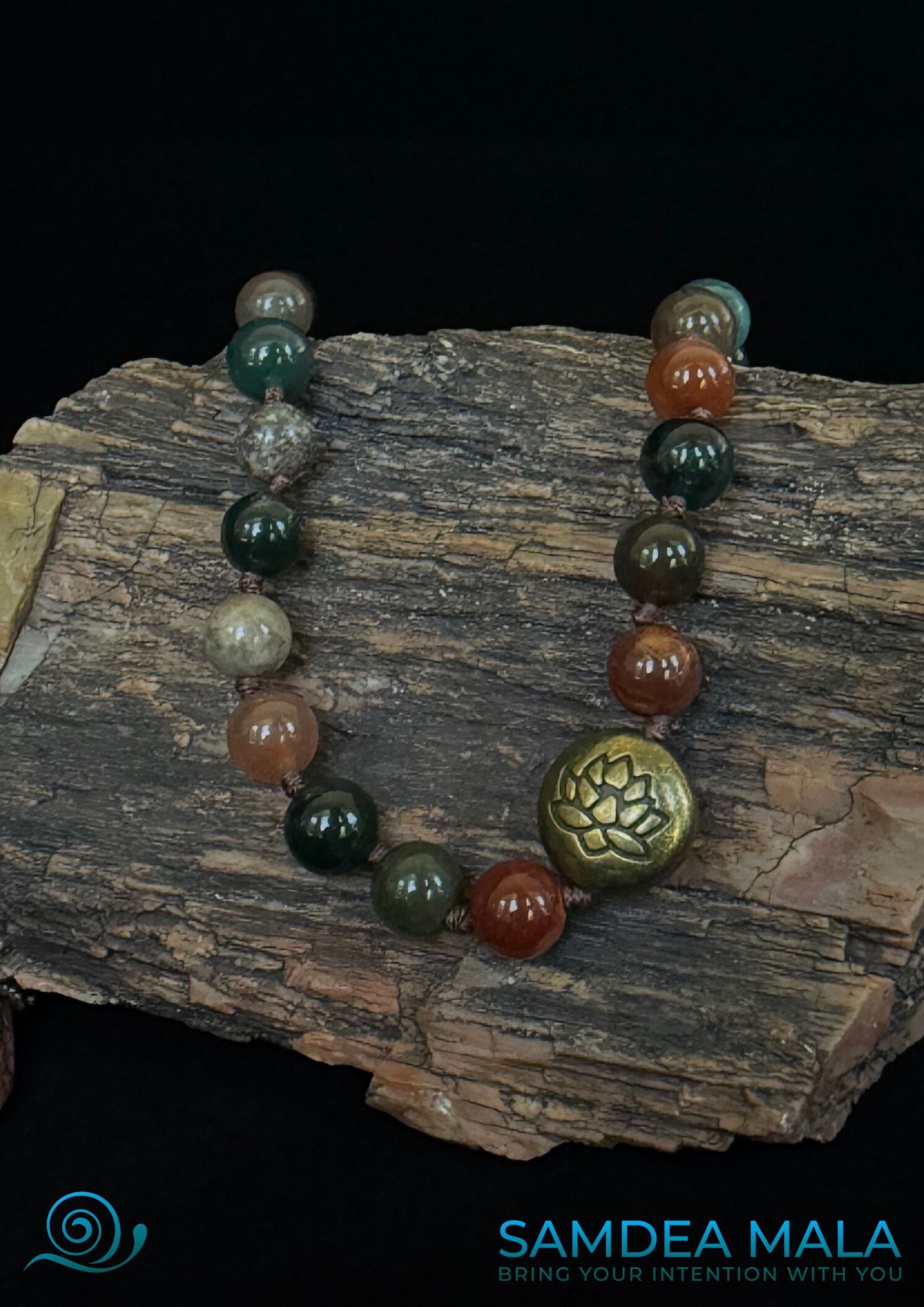 Close up of lotus bead of mala bracelet used in daily mindfulness rituals. Half mala with grounding stones for emotional balance. Sandalwood mala bracelet worn as everyday accessory.