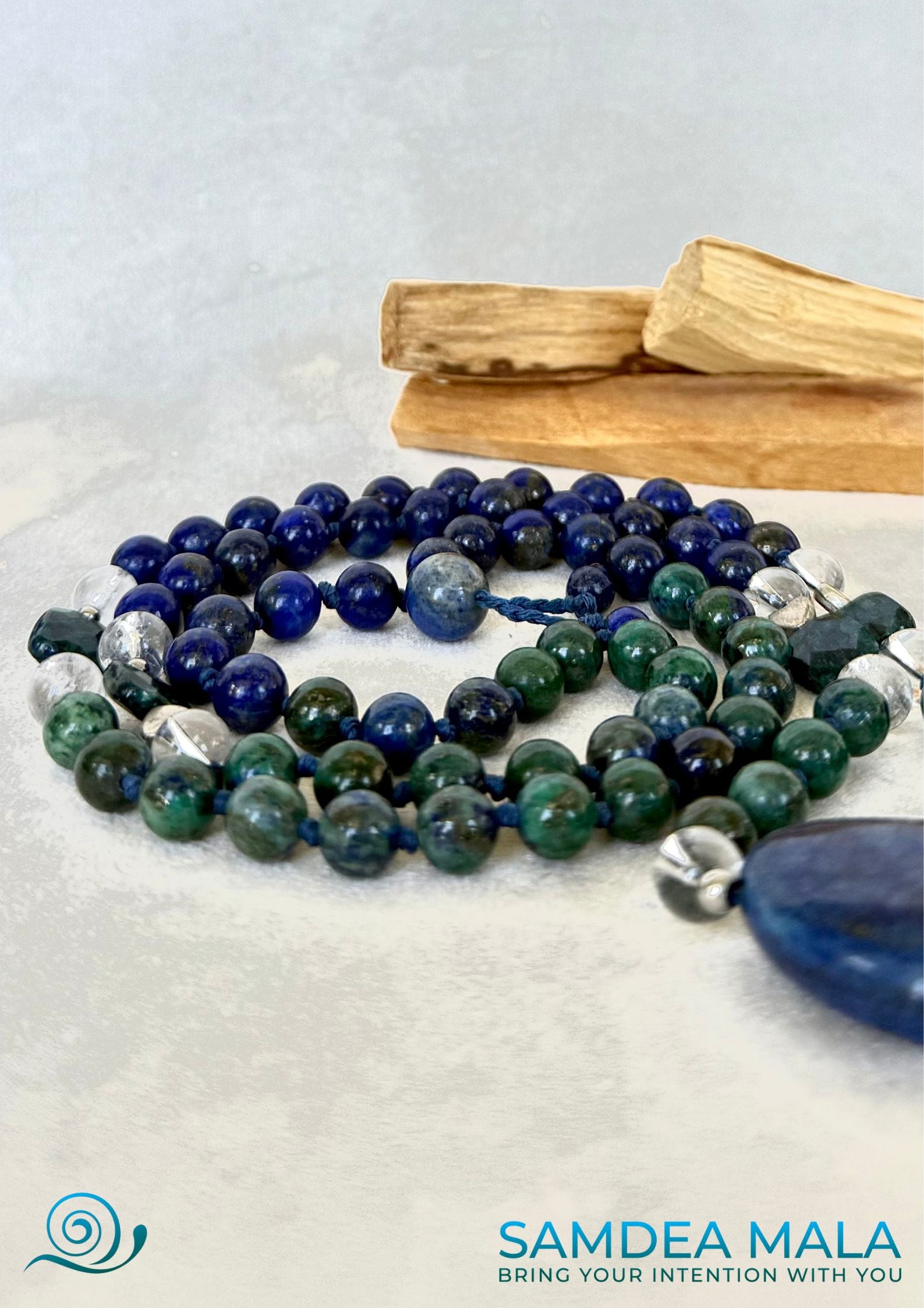 Samdea Mala Close-up of clear quartz and deep blue lapis lazuli stones, short mala beads with natual gemstones, blue and green, with chrysocolla for comunication.