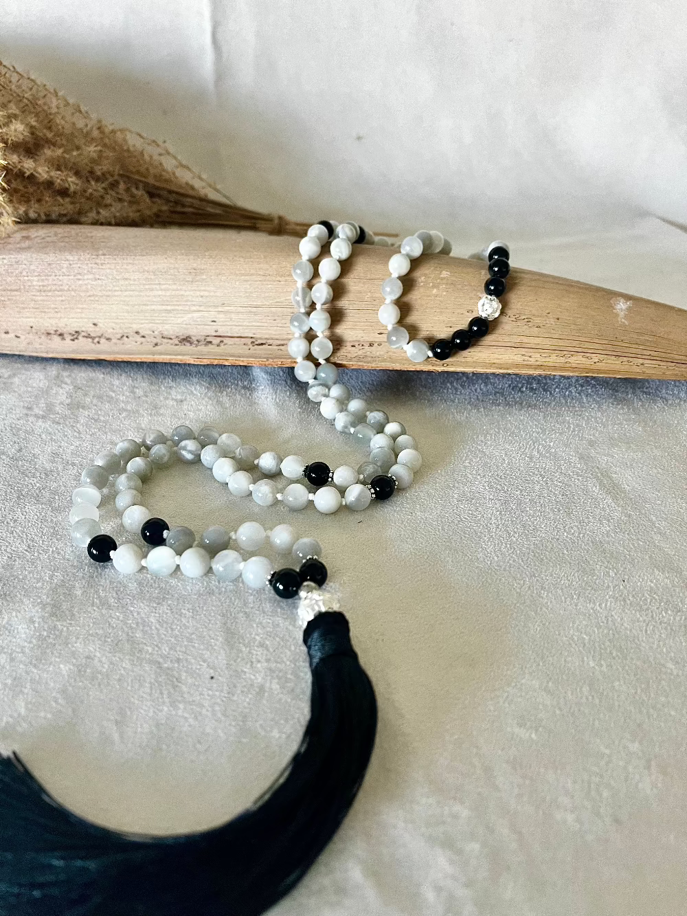 Empowering Full-length 108 mala beads laid out with tassel and silver finish