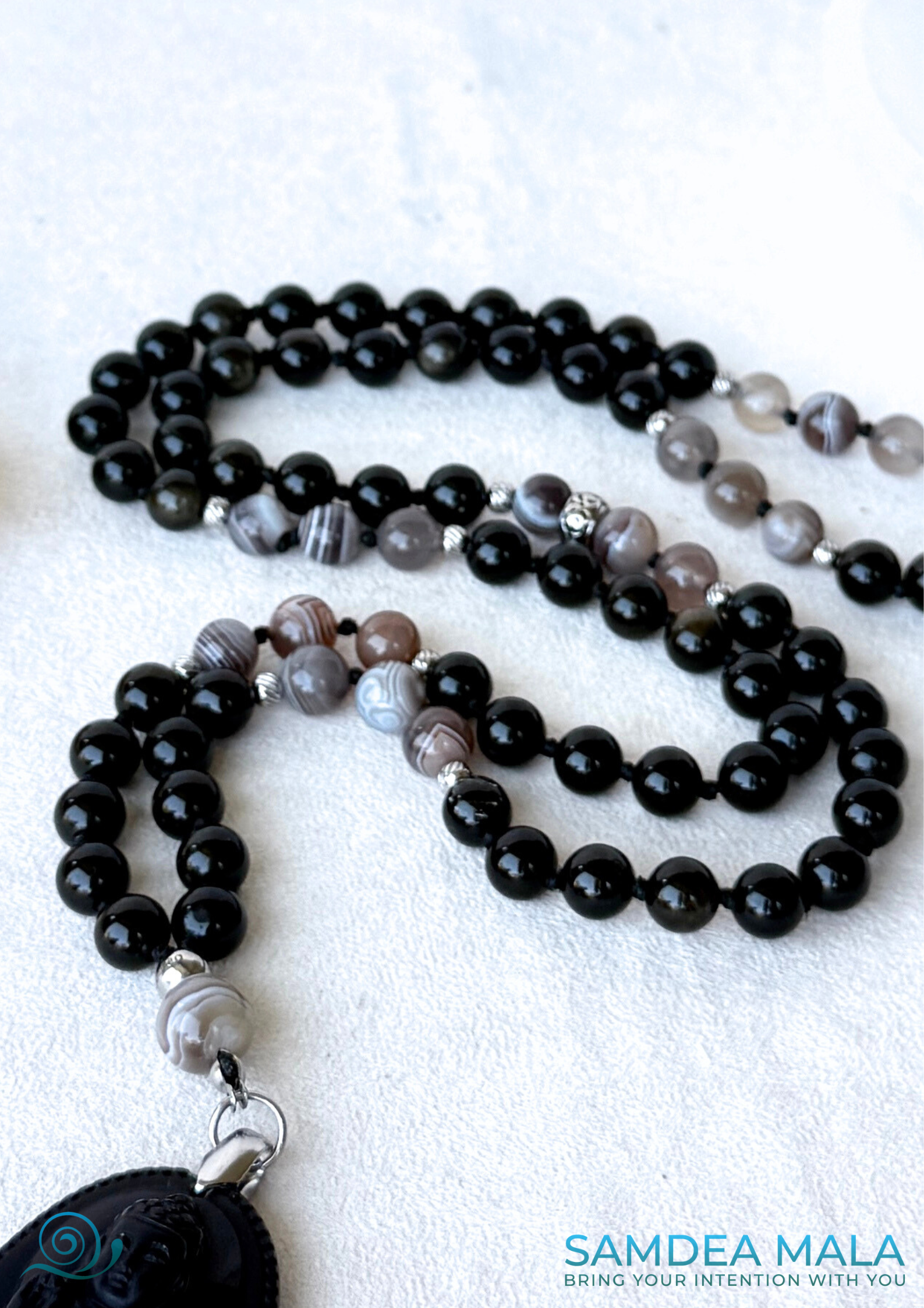 Detail of Obsidian and Botswane Agate hand-knotted gemstone beads