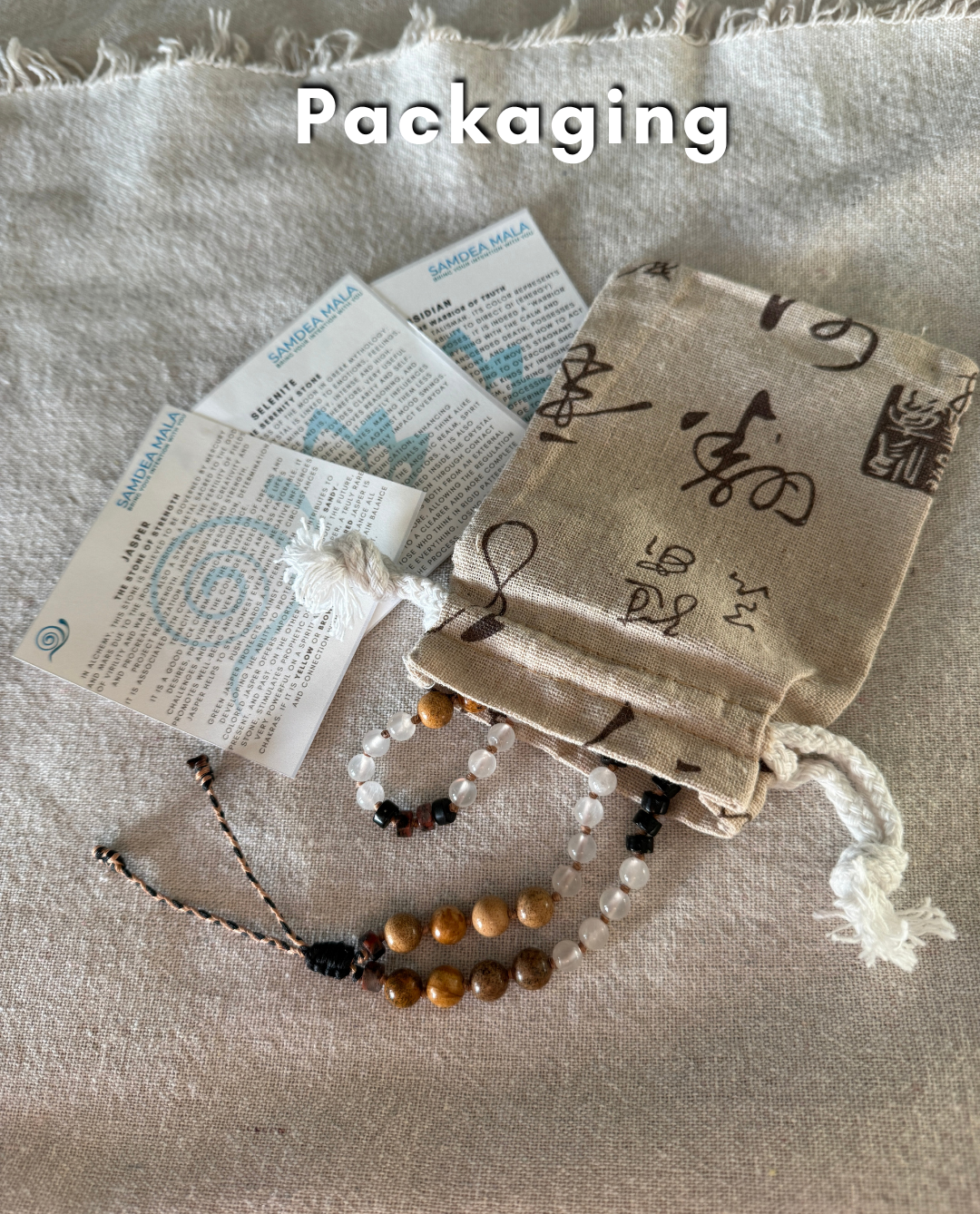 Packaging of natural gemstone Breath Mala in natural gemstones with stone descriptions and natural cotton pouch, designed to support mindful breathing and easy to carry with you every day.