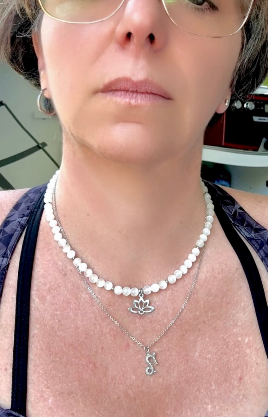 Spiritual selenite and lotus necklace worn as a talisman for purity and higher connection
