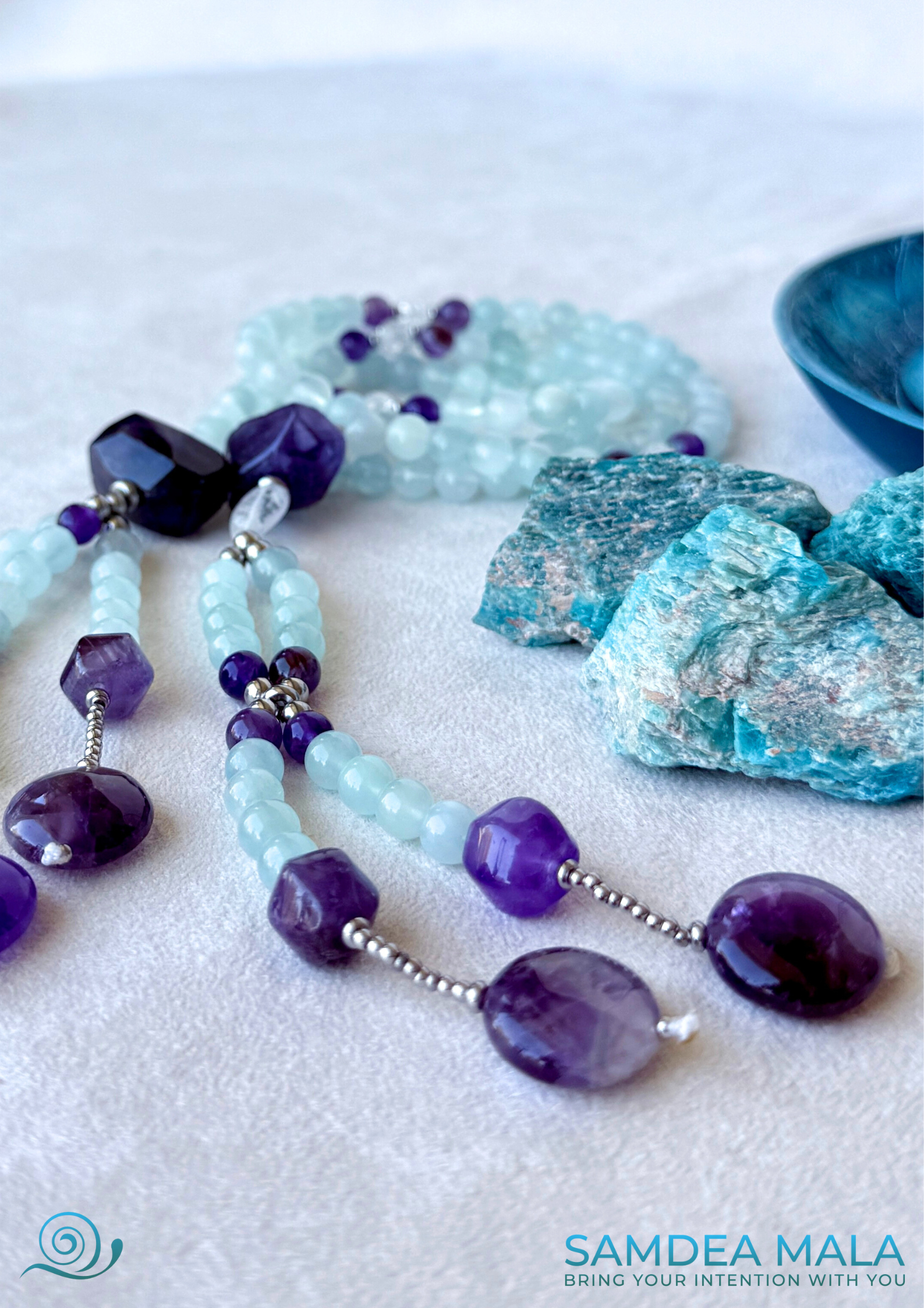 Detail of aquamarine and amethyst SGI juzu mala beads in the handmade Nichiren Buddhist mala for Daimoku practice.
