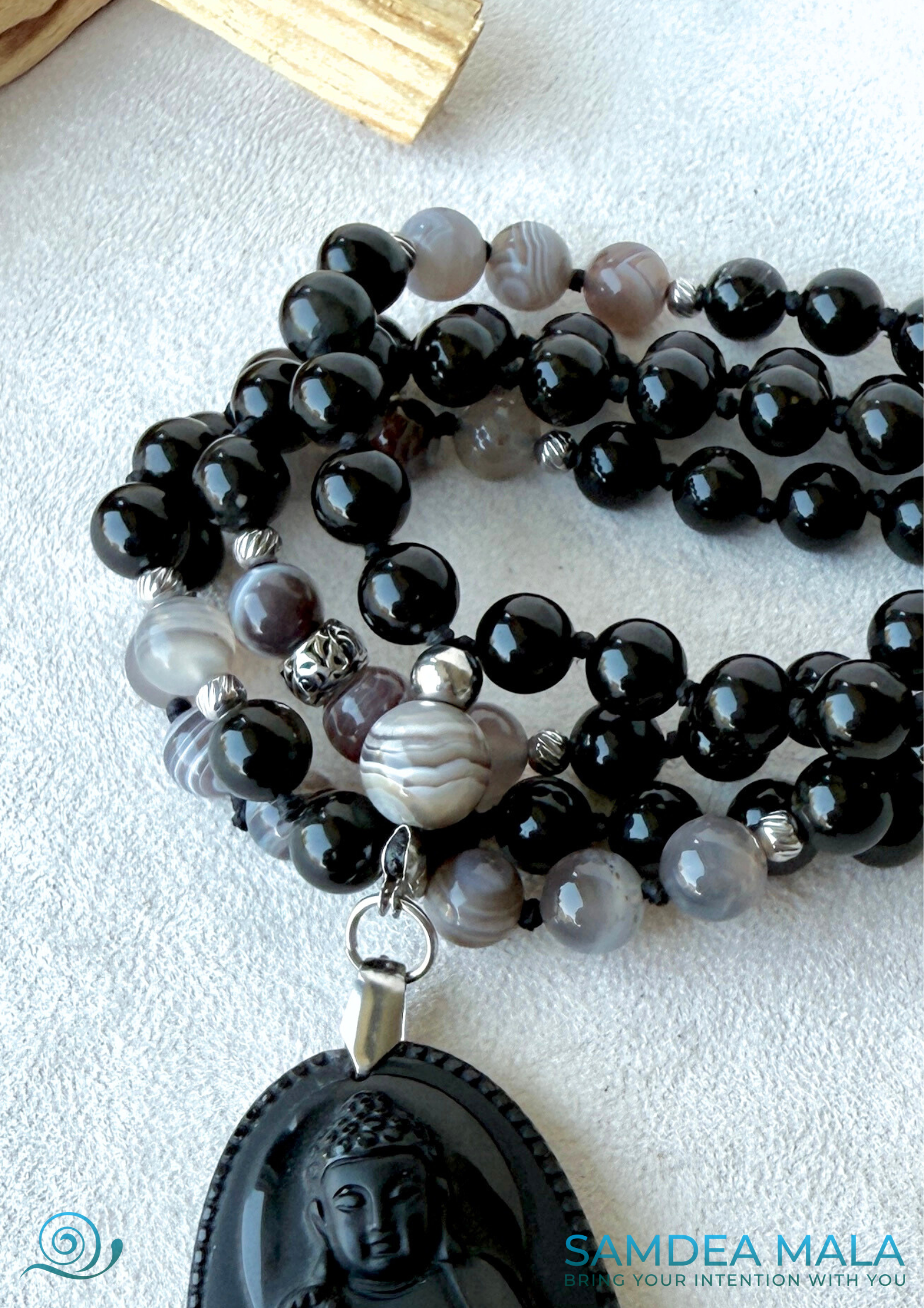 close up of Hand-knotted Obsidian and Botswana Agate mala with Buddha pendant for meditation and protection by Samdea Mala