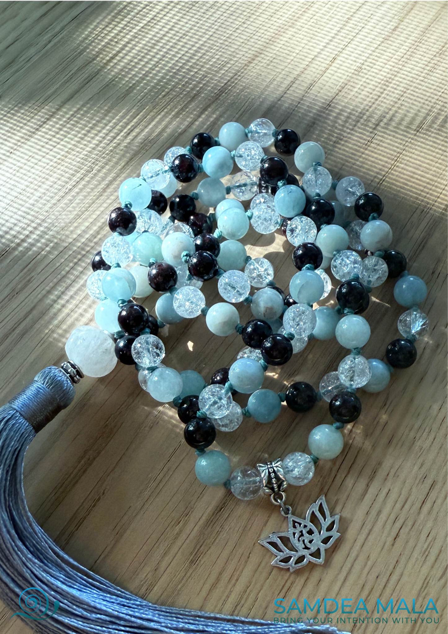 Garnet detail on customized mala necklace with lotus charm