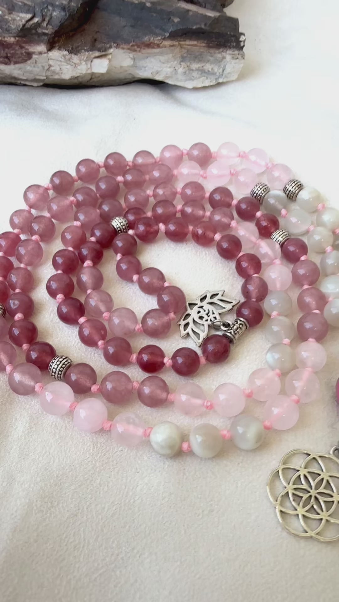 Video preview of Samdea Mala made of moonstone, rose quartz, and strawberry quartz with ceramic meru bead, Seed of Life pendant. Feminine energy mala beads.  Meditation mala for self-love, heart chakra and feminine connection.