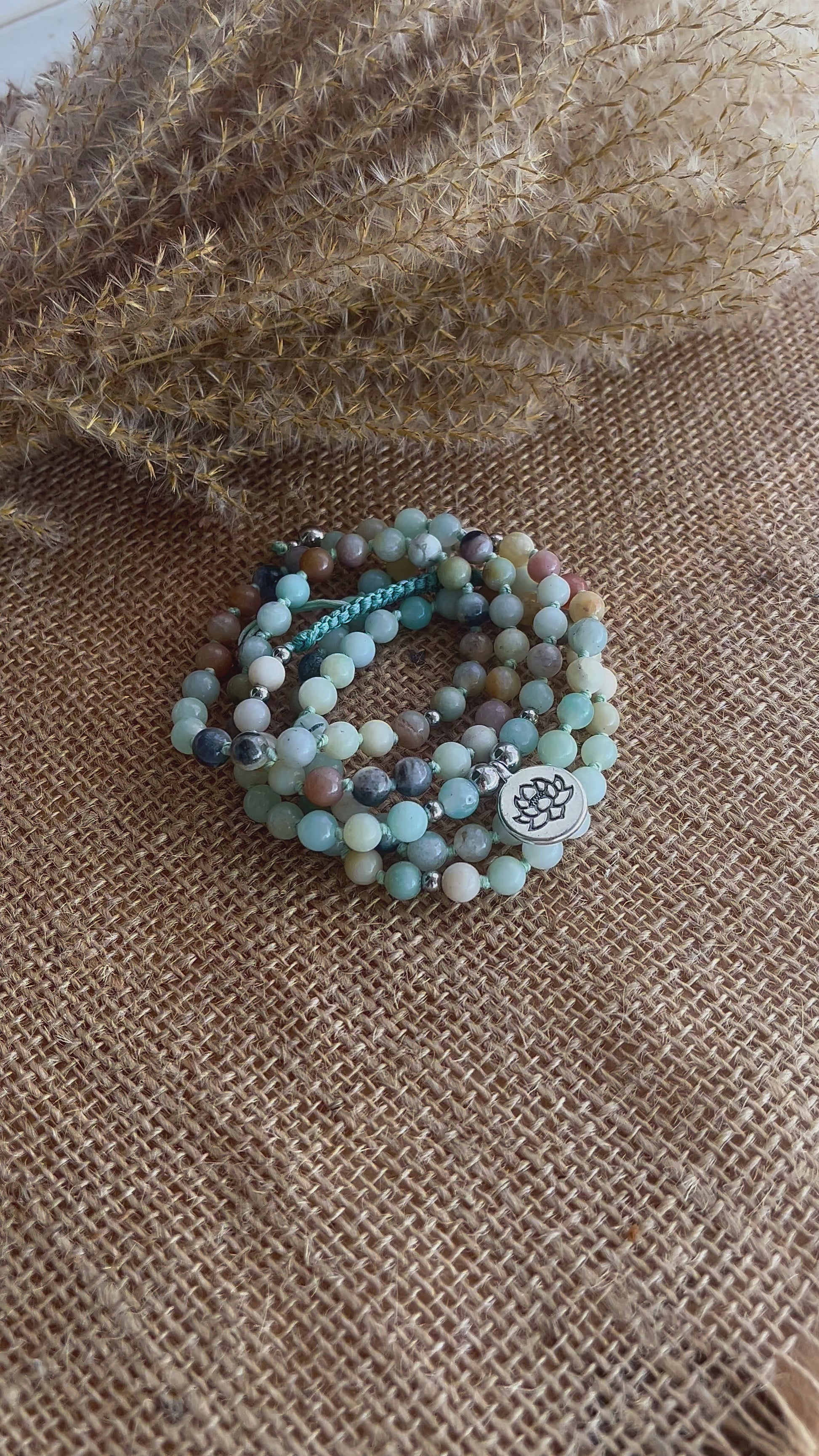 Video of mala bracelet in amazonite – adjustable mini mala with natural amazonite stones and a delicate lotus charm. Wrap-style spiritual bracelet for mindfulness and daily intention.