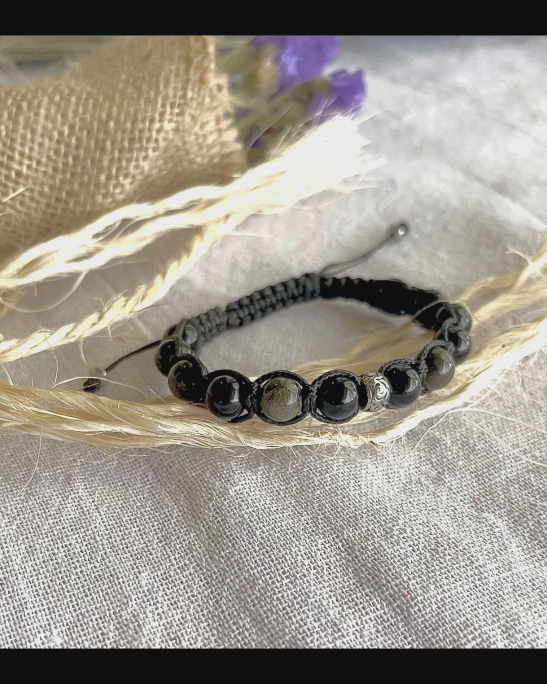 Video faeaturing Shamballa bracelet in natural obsidian, featuring black and gold beads on black cord.  The bracelet has a silver accent bead. Meditation bracelet, for mindfull growth, Grounding, Protection & Energetic Clarity
