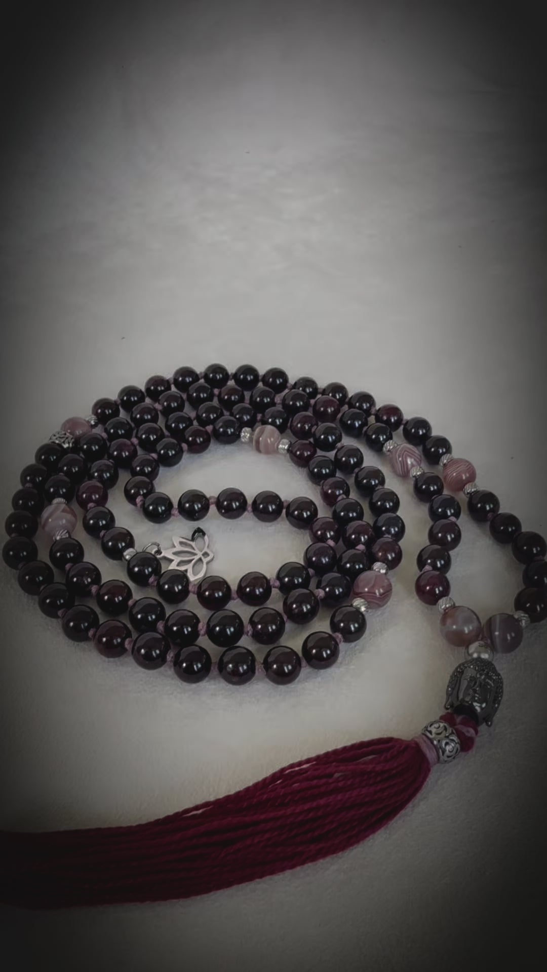 Video preview of Samdea Mala Custom mala with tassel; mala necklace in purple, bordeaux mala beads with Buddha and lotus charm, for protection and light.