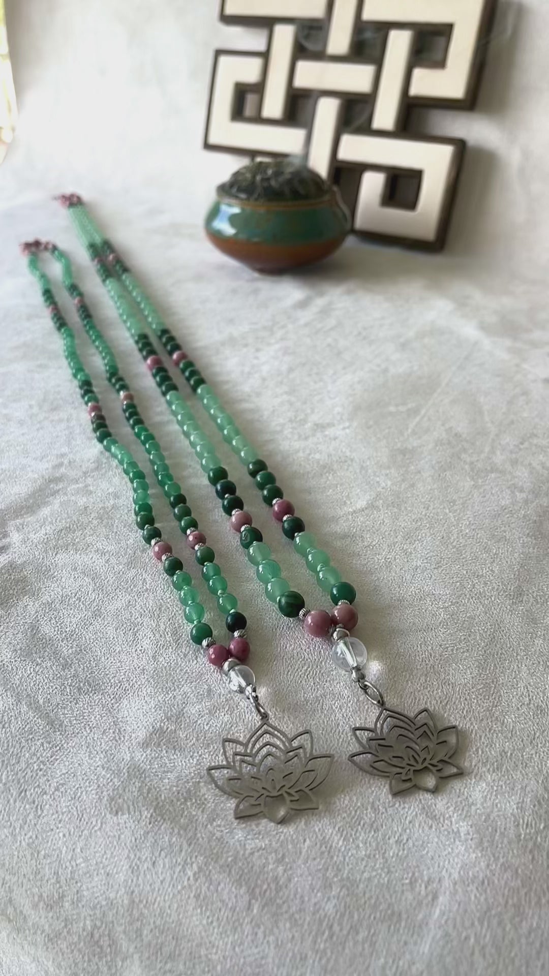 Flat lay of Taurus mala and mini mala beads with quartz meru stone for clarity and growth