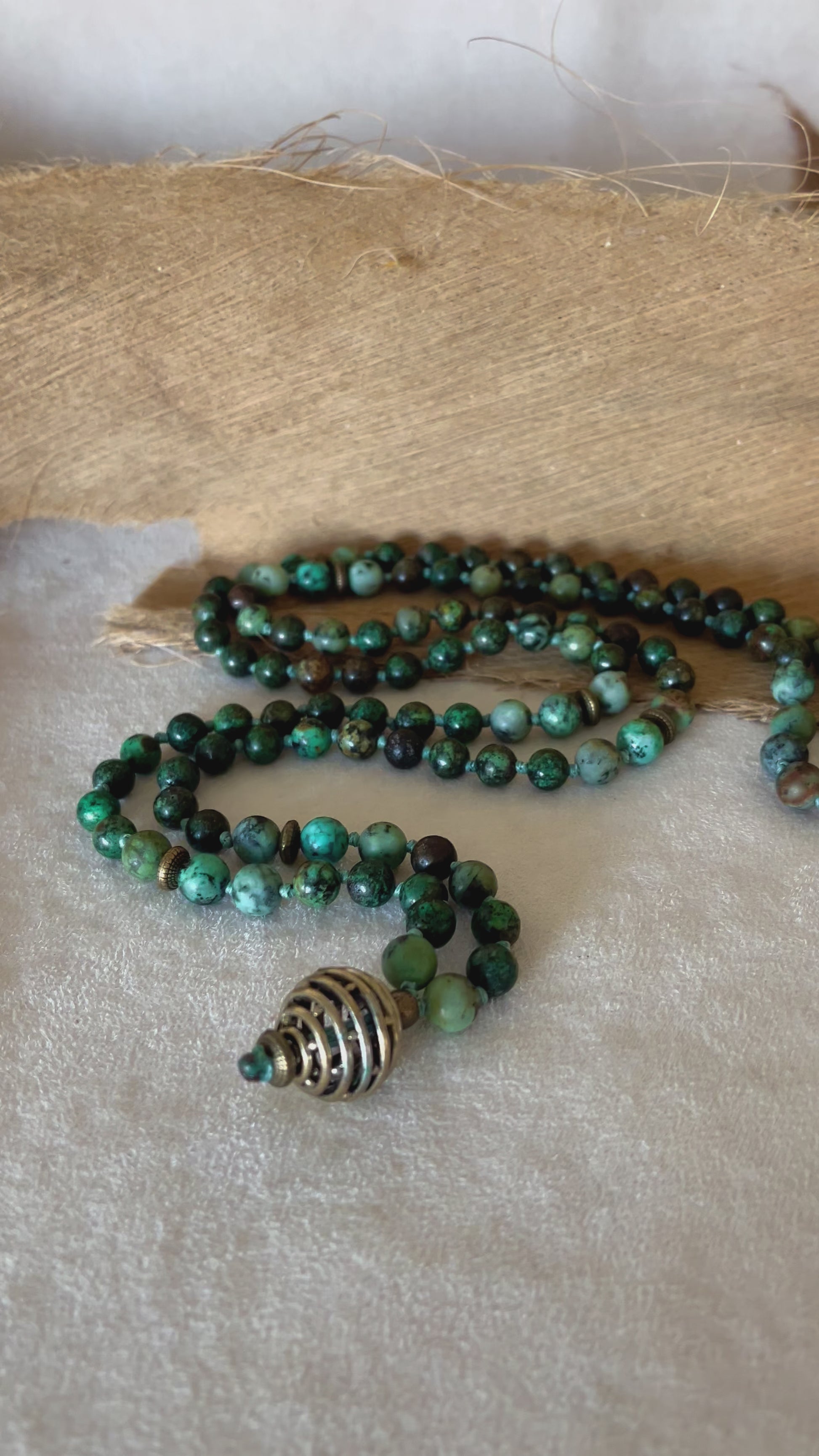 video of hand-knotted Turquoise Jasper mala beads showing stone texture and calming green-blue tones