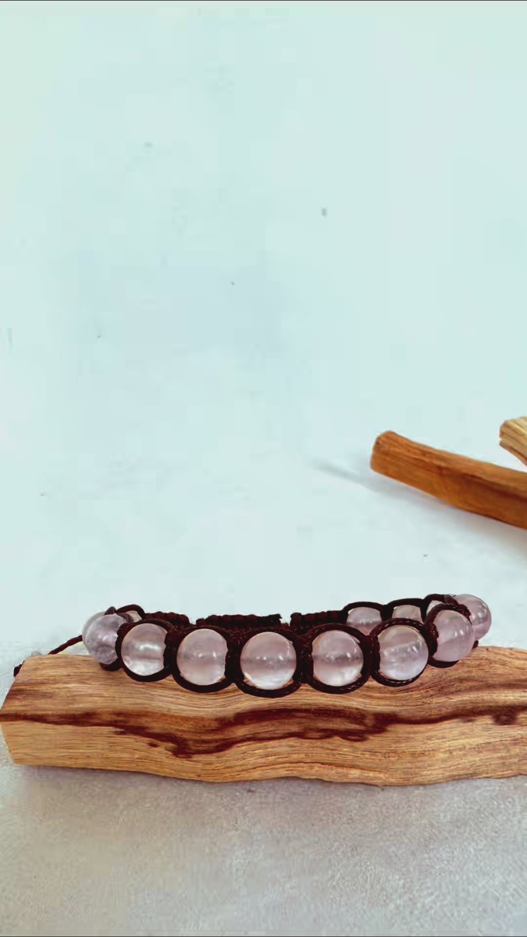 Video preview Tibetan style bracelet in rose quartz, rose quartz mala beads for self-love. Tamashii-inspired bracelet . Rose quartz spiritual bracelet with Tibetan style knot. Gentle and calming crystal bracelet in soft pink. Meditation bracelet with natural rose quartz stones.