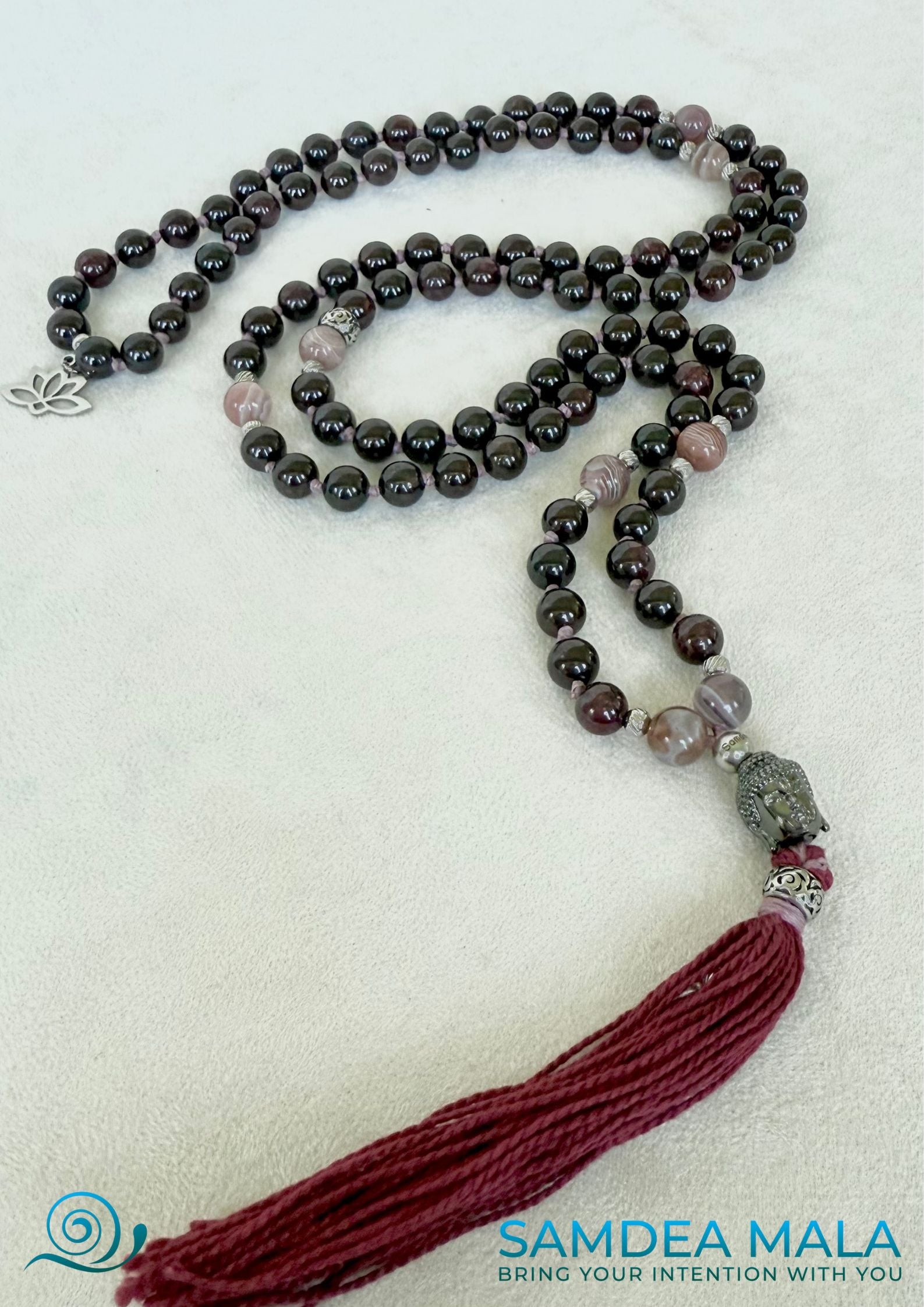Full view of 108 prayer beads for a spiritual gift. Custom mala with tassel; purple, bordeaux mala beads with Buddha and lotus charm, for protection and light.