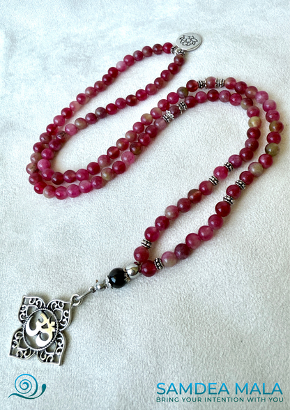 Mala necklace in watermelon tourmaline for heart chakra healing. Heart chakra mala beads necklace with OM and lotus charm. Mala for Meditation for women with watermelon tourmaline and garnet for heart protection and clarity with Anahata chakra pendant.