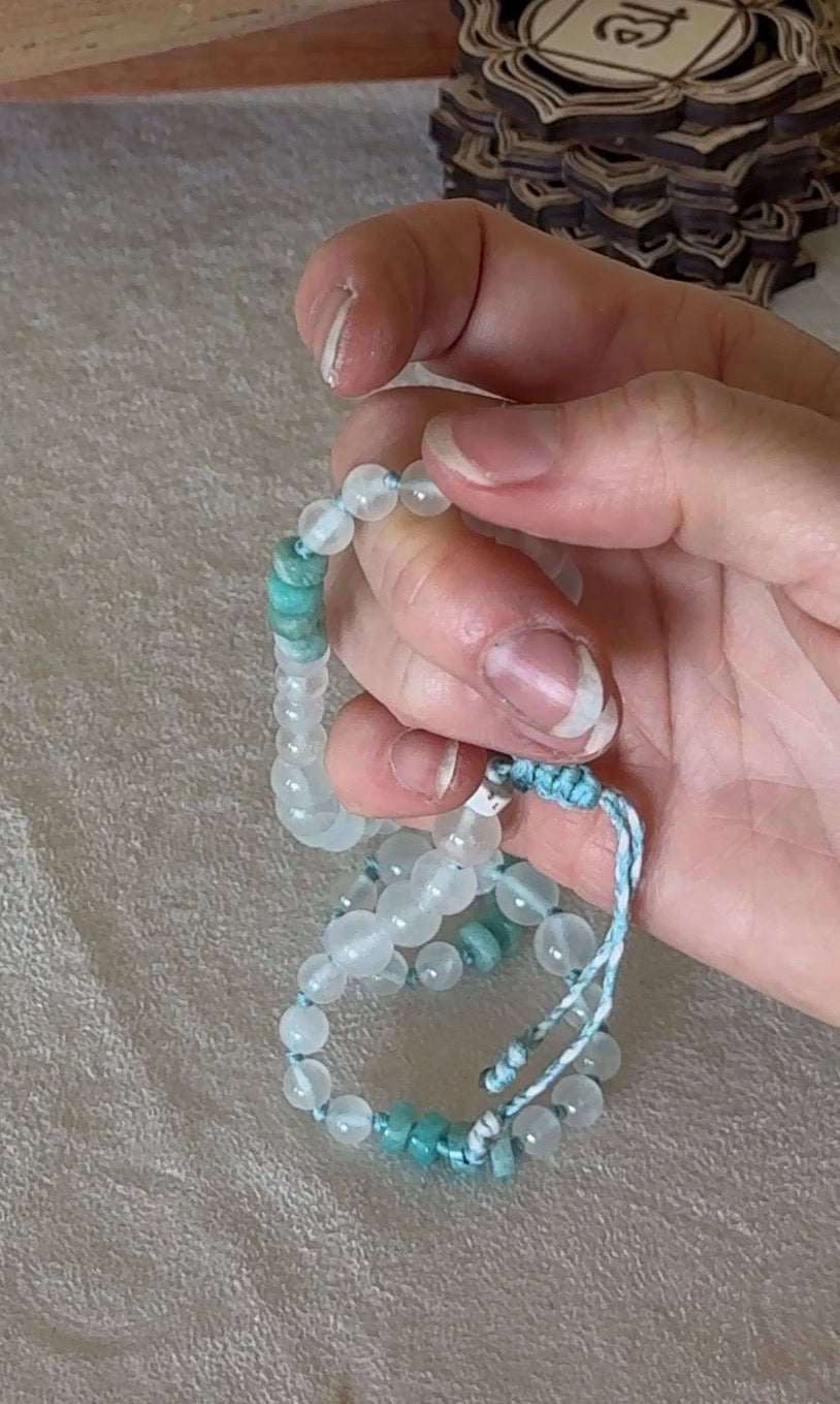 Natural gemstone box breathing mala with groups of four beads to guide inhale, hold, exhale, and hold during breathwork. connect to your body. in hand.