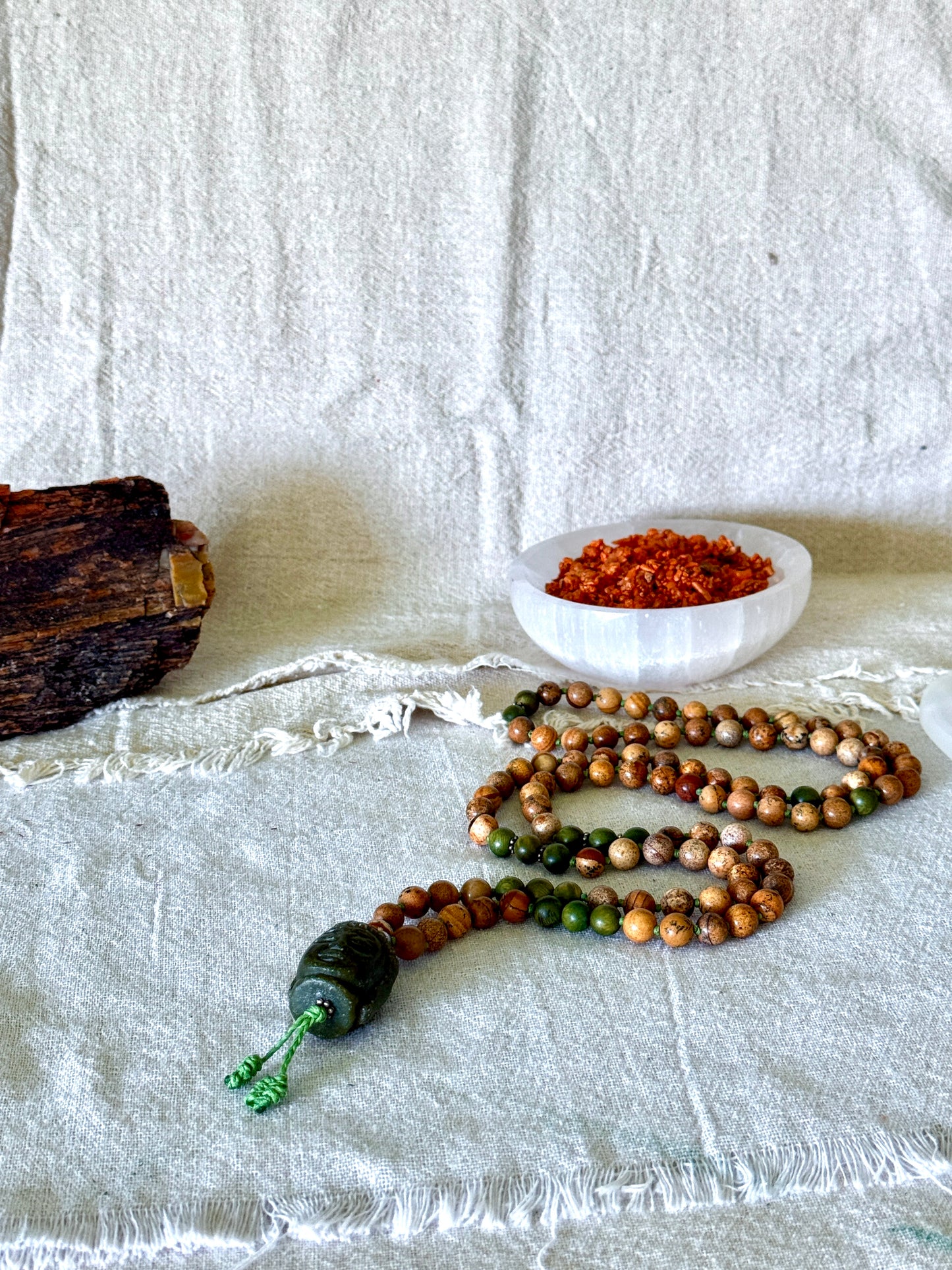 Genuine sandalwood mala necklace with 108 hand-knotted beads, earthy sand jasper, and Jade Buddha meru bead