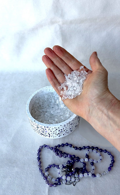 Close-up of bowl with clear quartz and amethyst crystals for energy cleansing