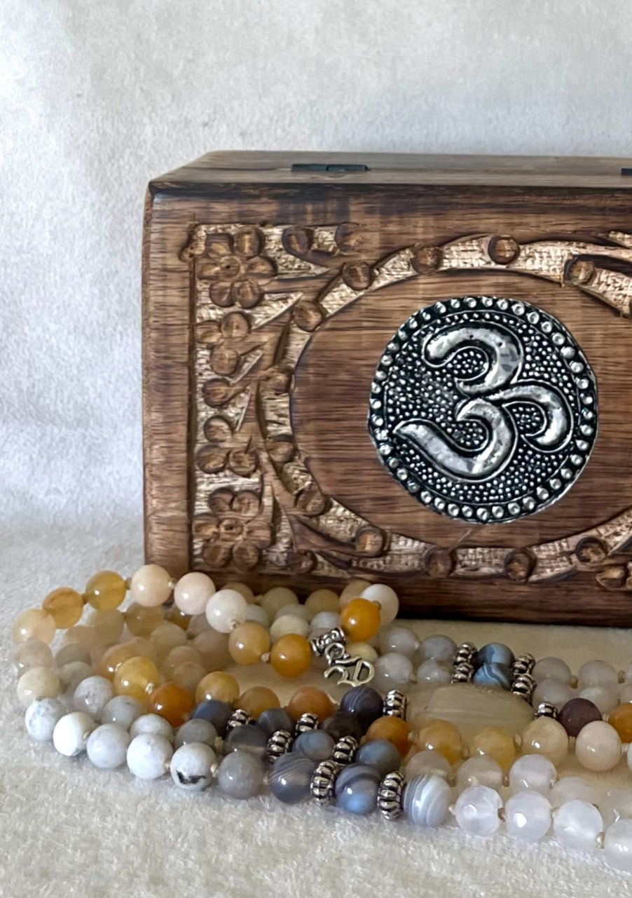 Custom Guru Mala piece in a wooden box, personalized stone arrangement around the guru bead