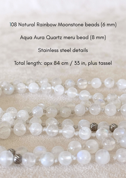 Detail of a  Handmade Rainbow Moonstone mala for meditation with 108 prayer beads, 6 mm natural gemstone beads, Aqua Aura Quartz meru, stainless steel details, small lotus charm, and tassel, created for meditation, breathwork, mantra repetition, mindfulness, and intentional practice. Samdea Mala