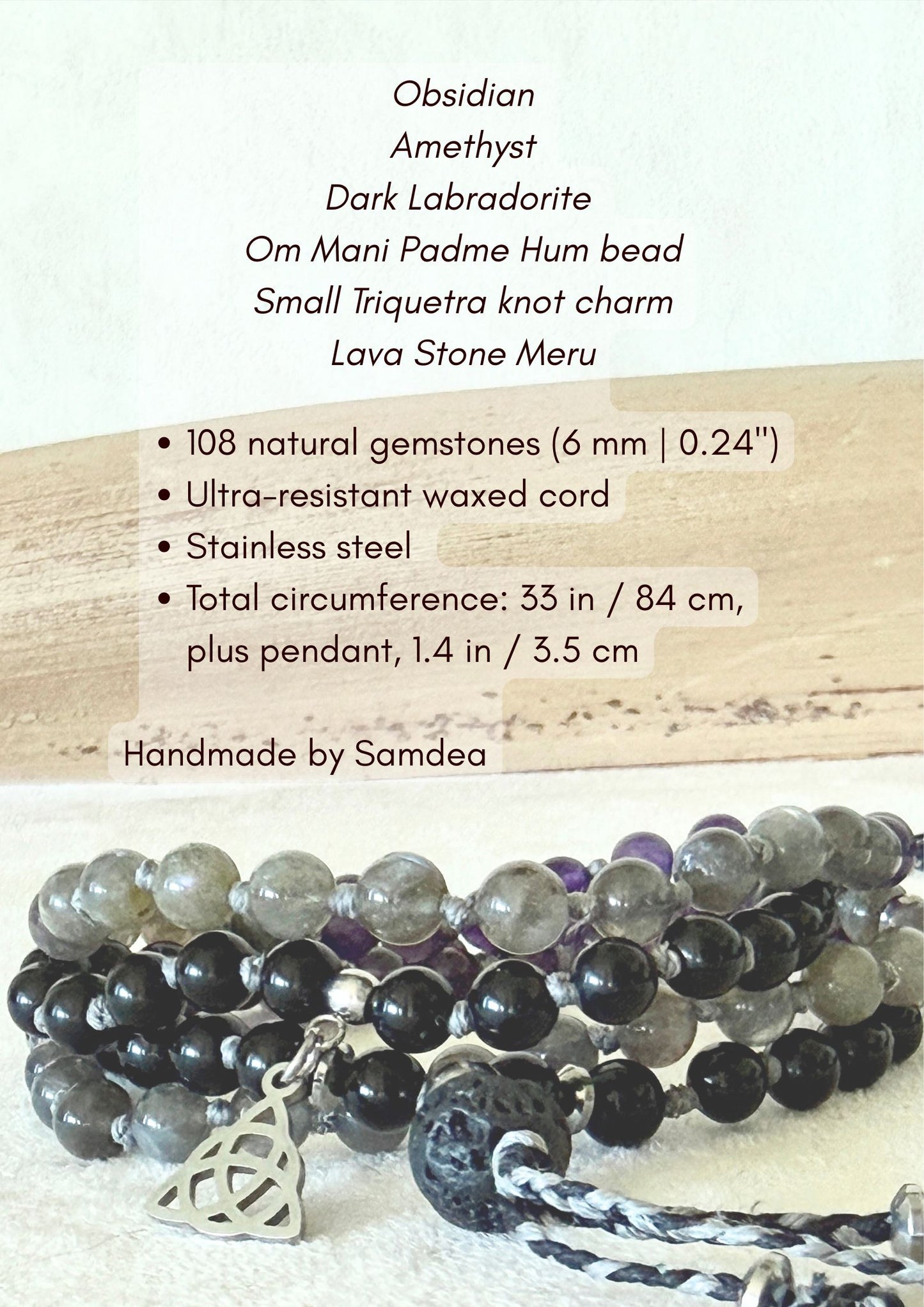 Detail view of the Shadow Work Mini Mala showing the engraved guru bead, Triquetra charm, and lava stone meru amid amethyst and labradorite beads.
