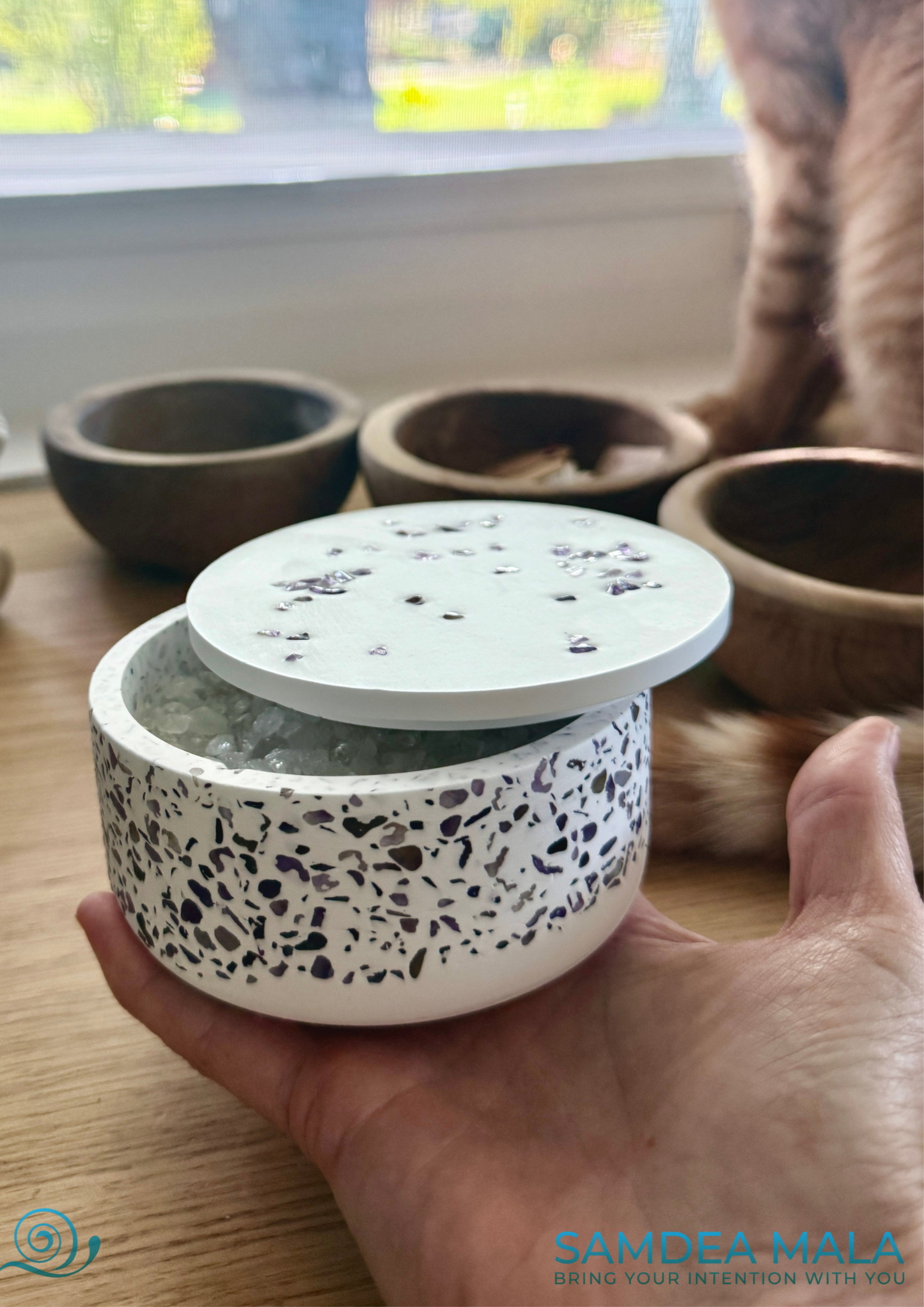 Energy and purifying bowl for purifying and recharging mala necklace and healing stones on a hand for dimension