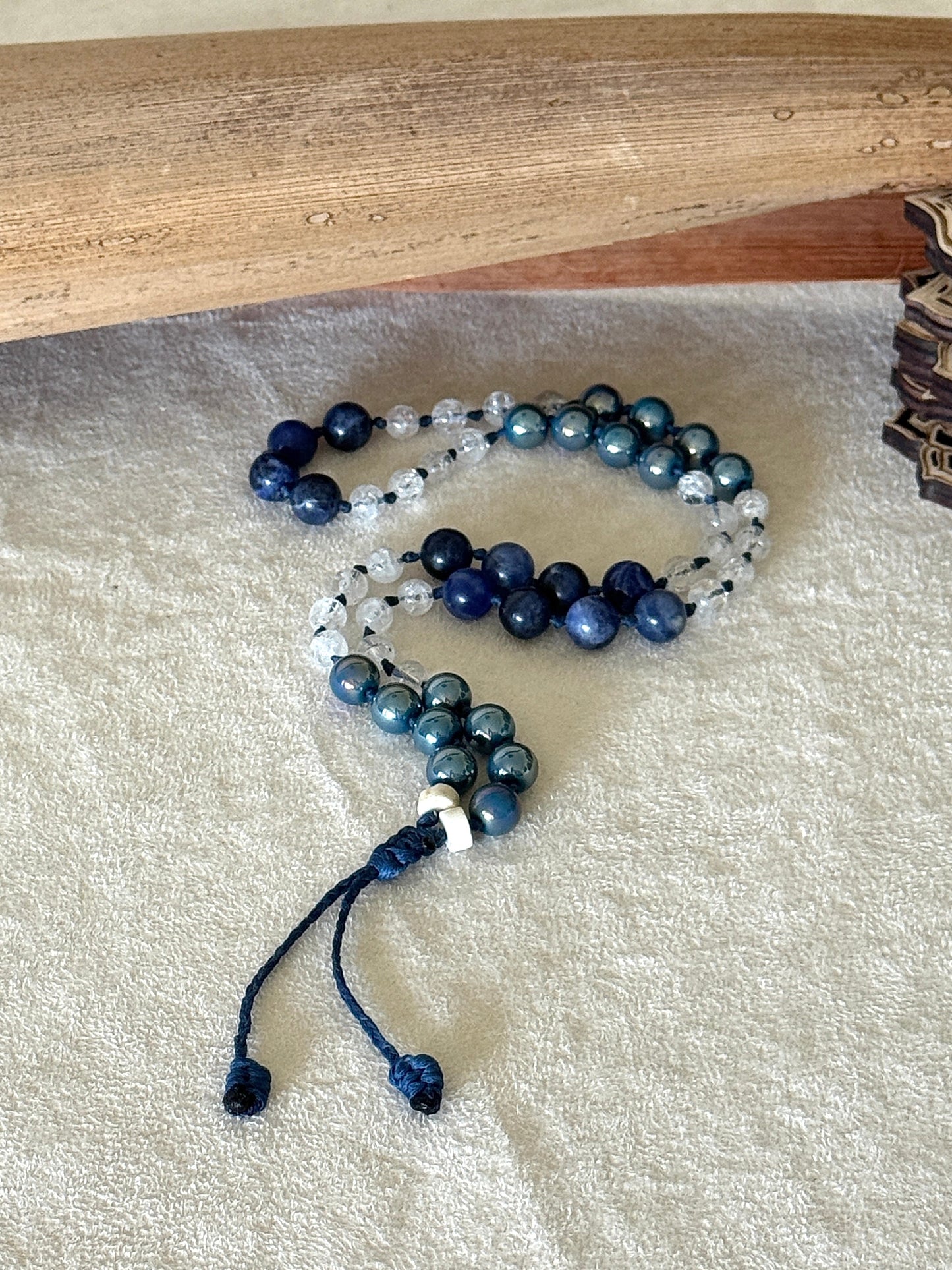 Full view of natural gemstone box breathing mala  bracelet with groups of four beads to guide inhale, hold, exhale, and hold during breathing practice. 