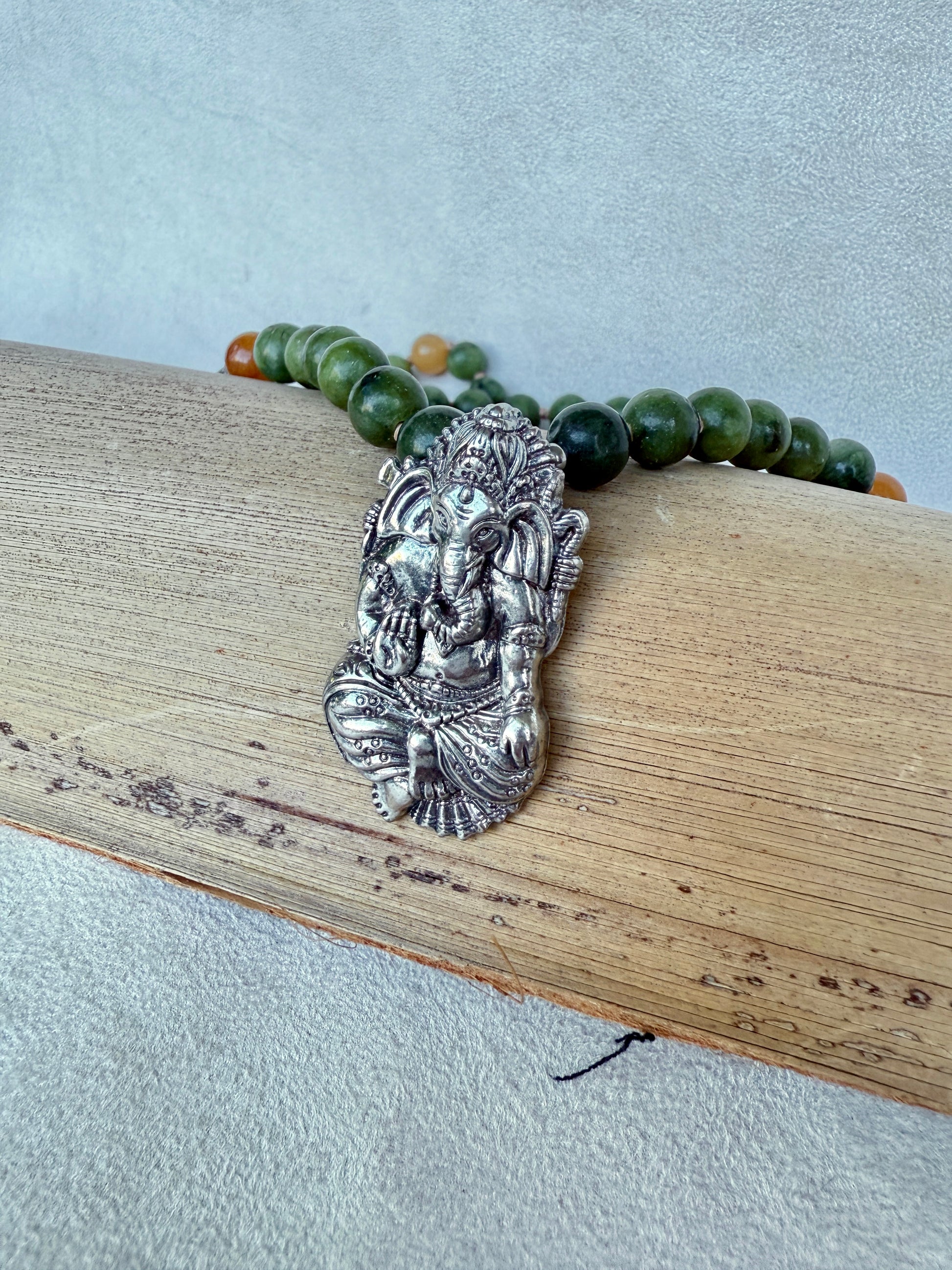 Detail of antique-style Ganesha pendant symbolizing removal of obstacles