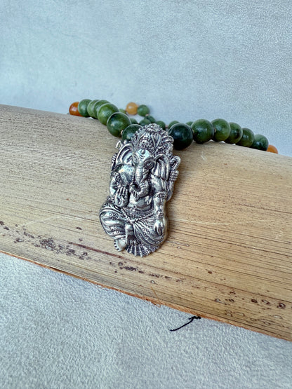 Detail of antique-style Ganesha pendant symbolizing removal of obstacles