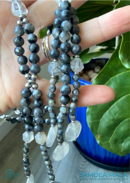 Gray SGI juzu with tassels on a hand