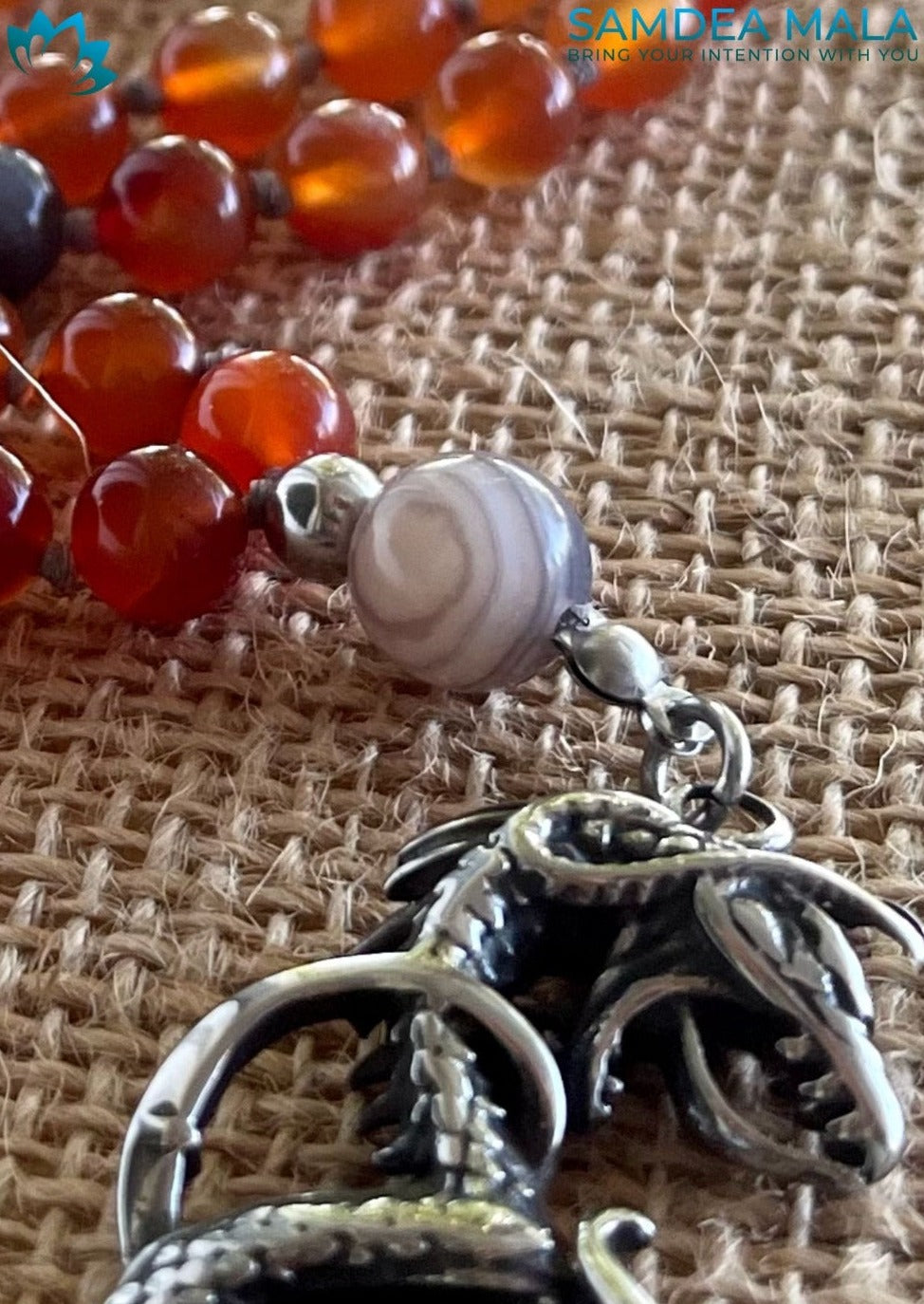 Guru Mala example showing the guru bead and personalized crystal selection