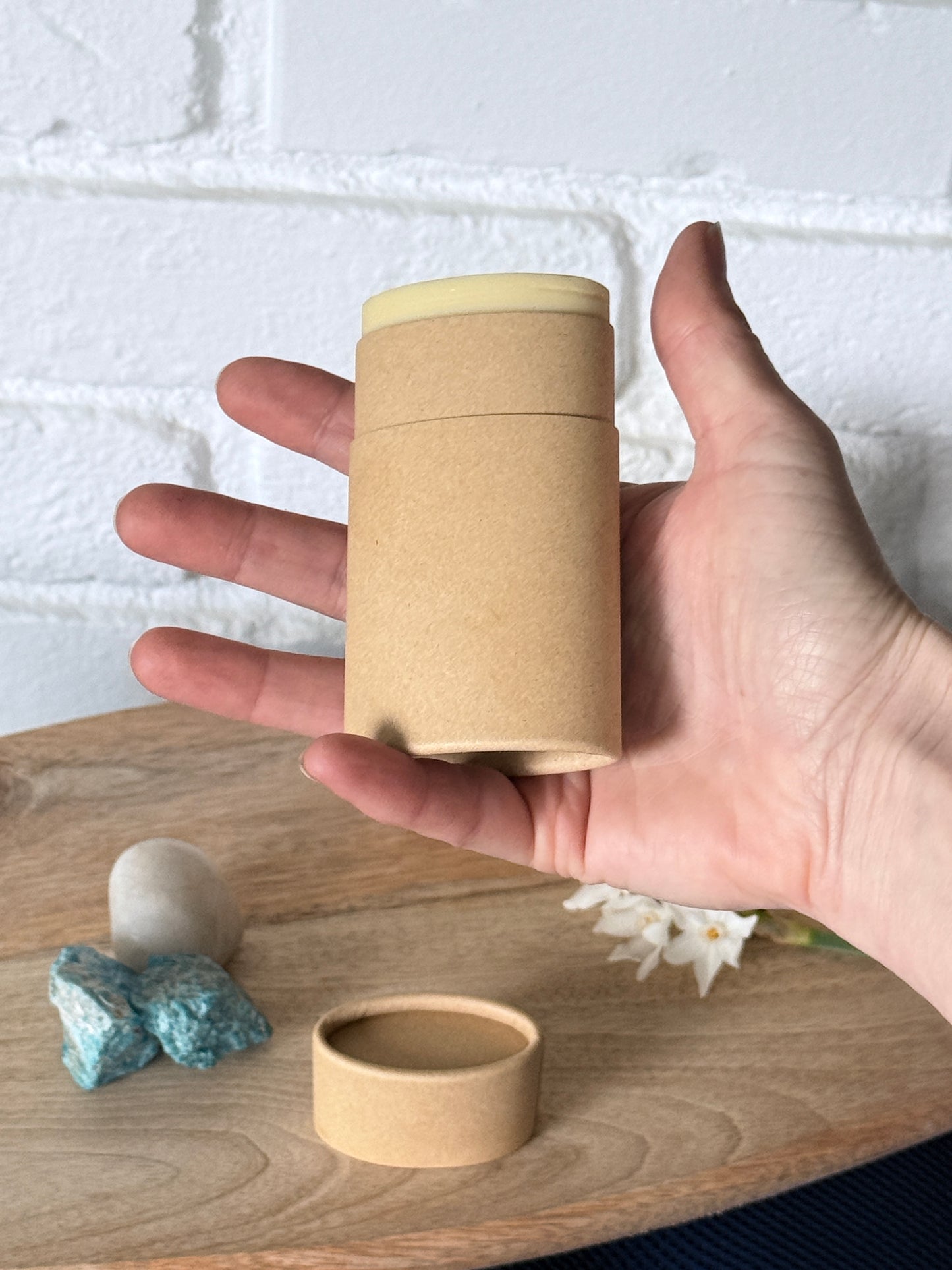Hand holding a Deodorant stick twist-up packaging, clean non-toxic daily deodorant